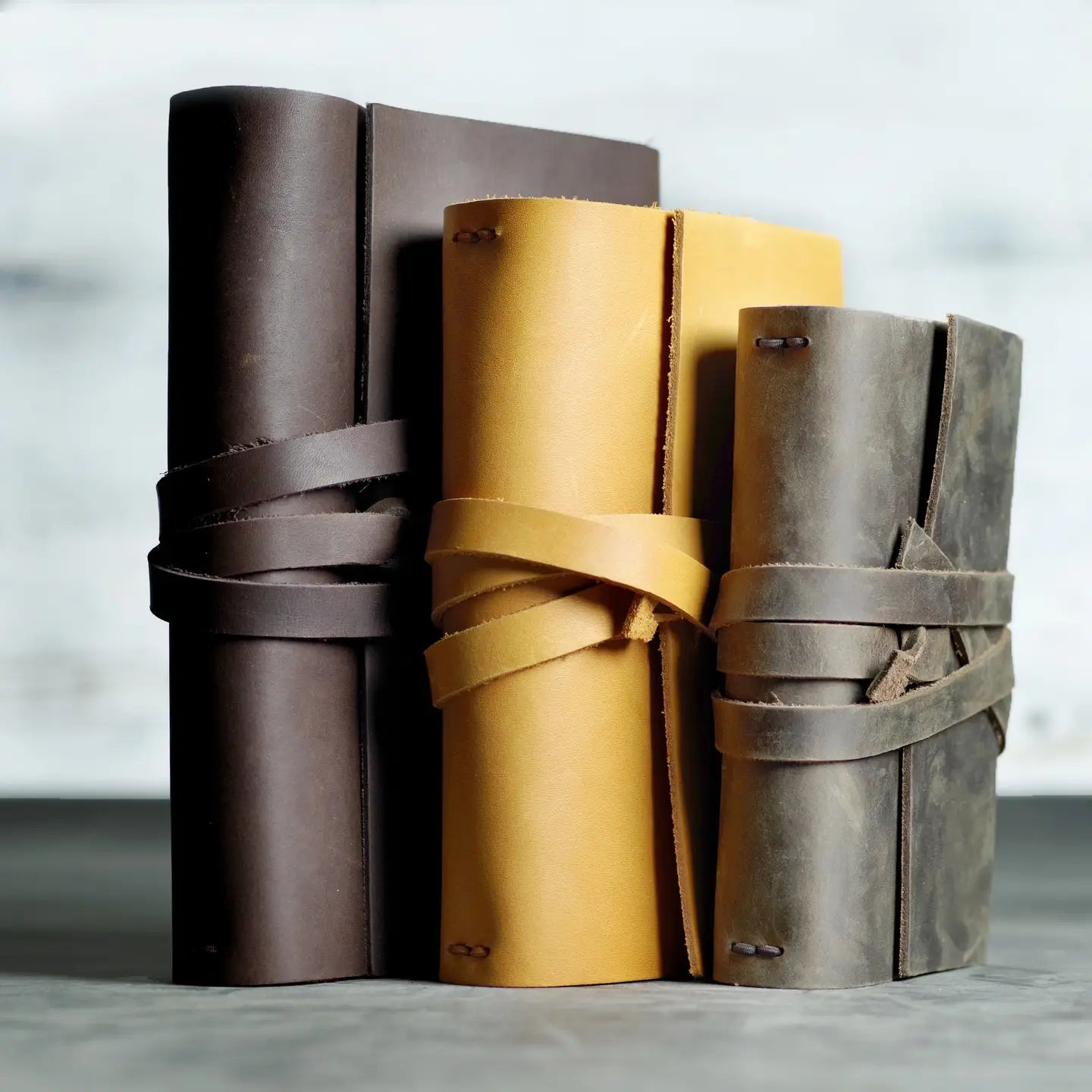 stack of leather notebooks in different colors, premium custom branded stationery