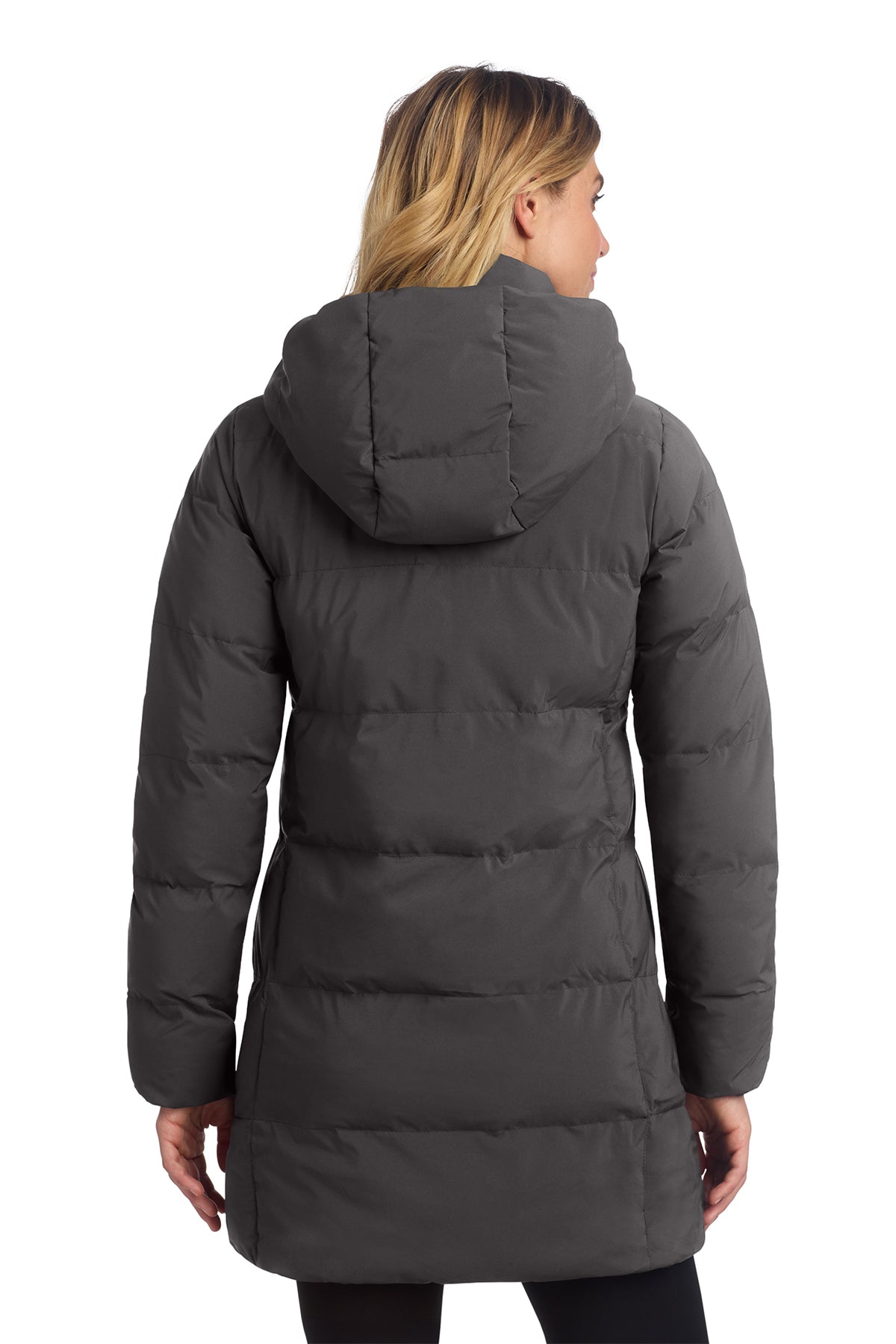 Woman wearing a gray puffer coat on a white background