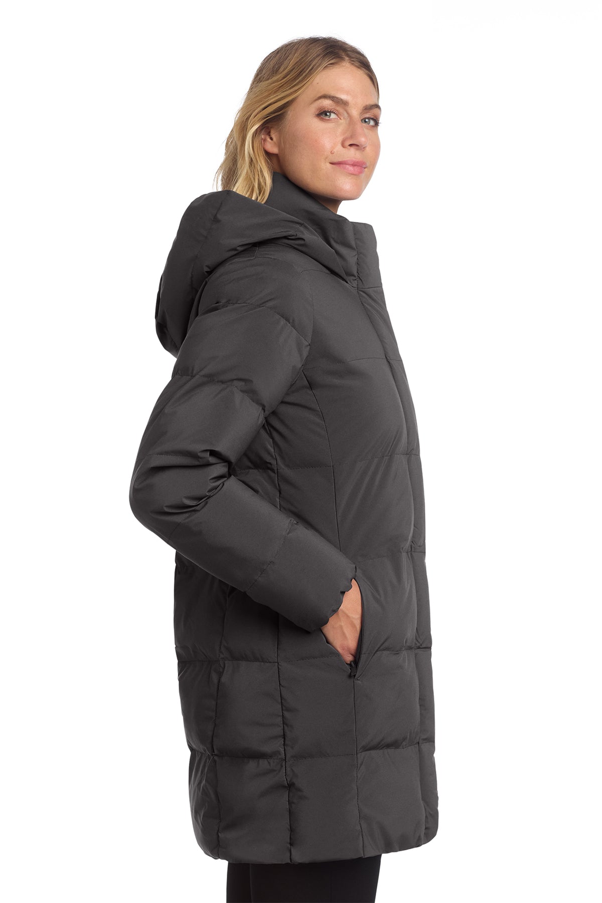 Woman wearing a black puffer coat on a white background