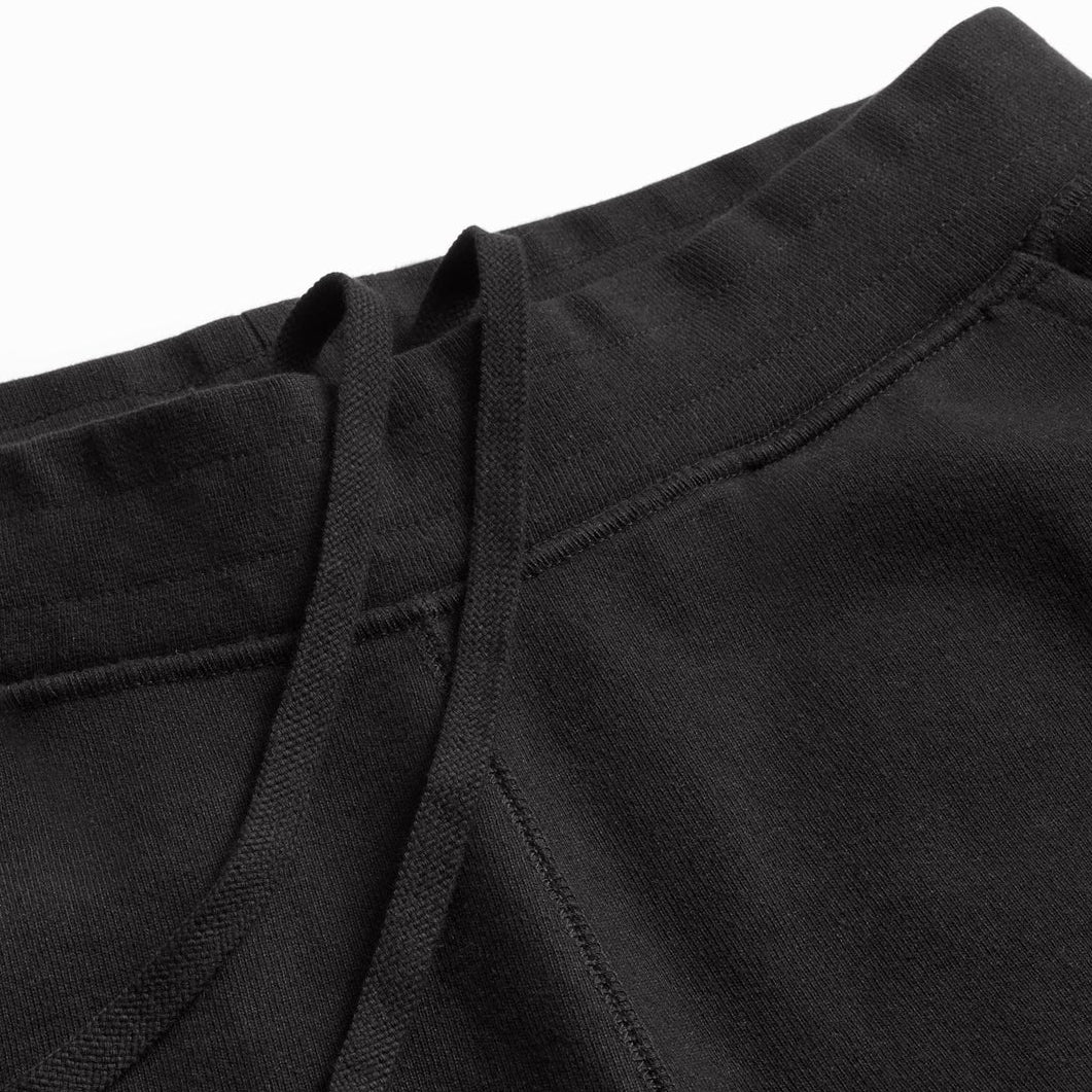 black jogger pants fabric detail close-up, organic cotton texture for sustainable custom apparel