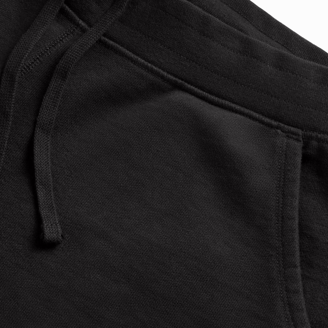 black jogger pants stitching and fabric detail close-up, high-quality organic cotton branded apparel