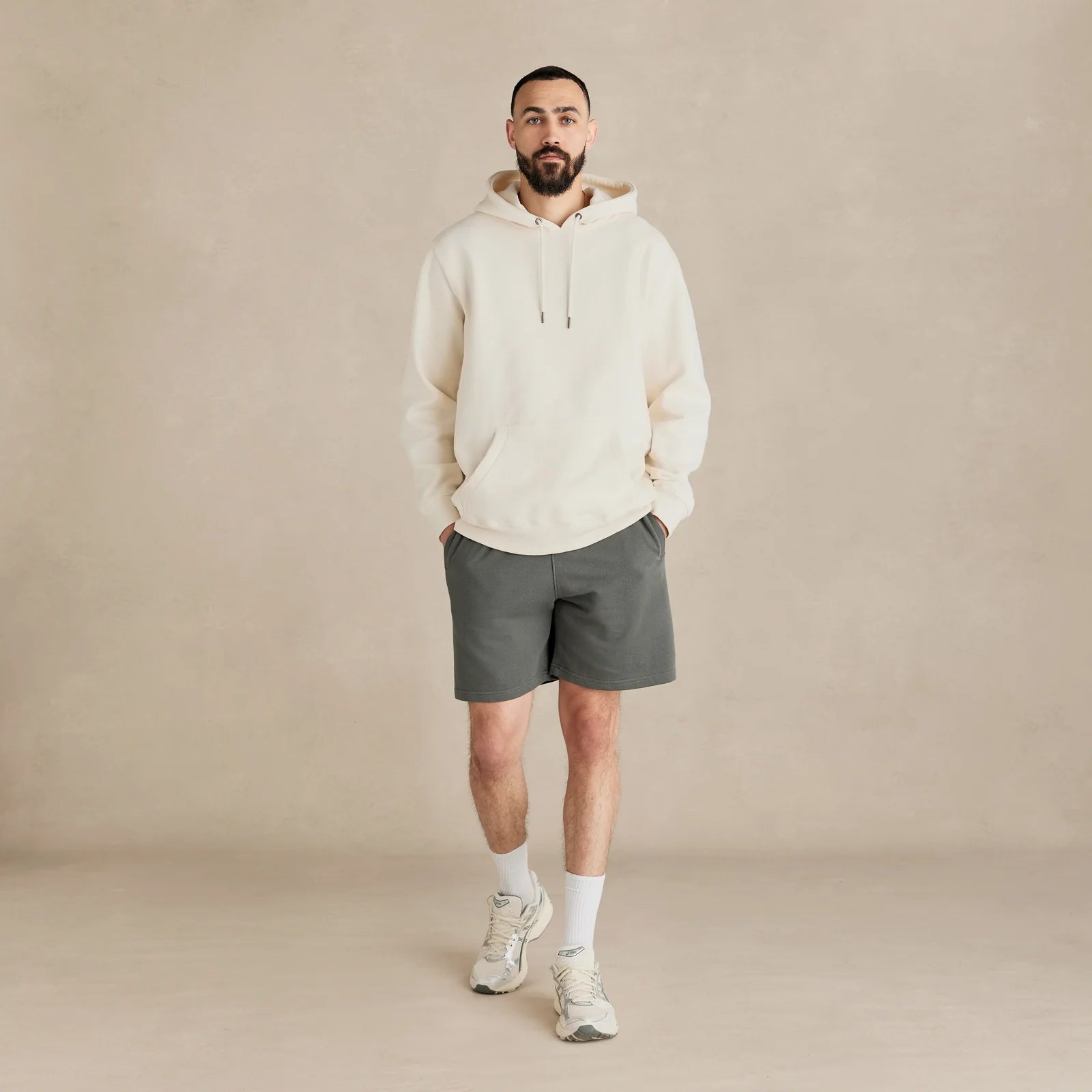 EMERCYN Essential Hoodie – cream men’s premium cotton hoodie styled on male model