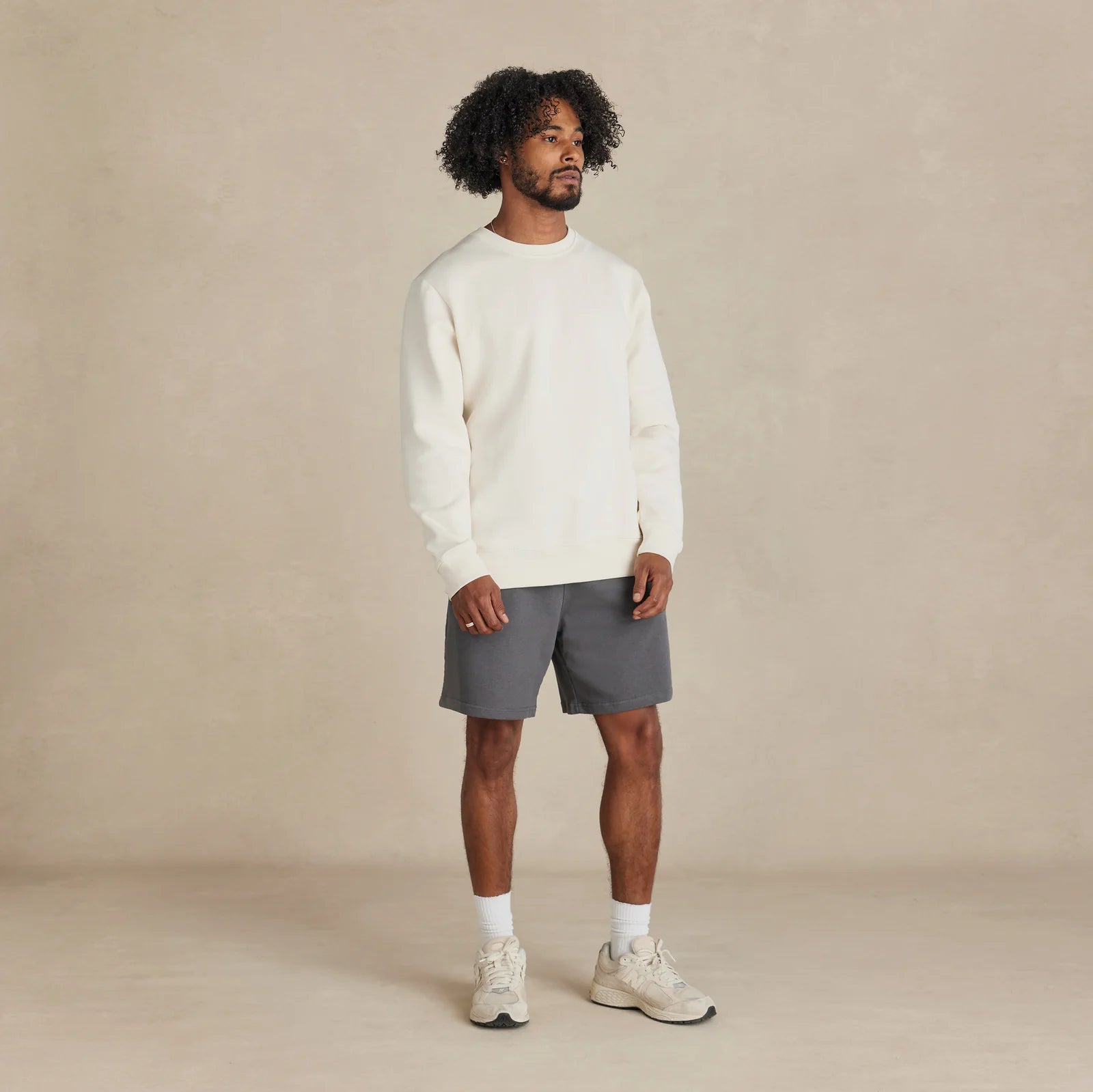 EMERCYN Essential Crewneck – white unisex premium cotton sweatshirt worn by model