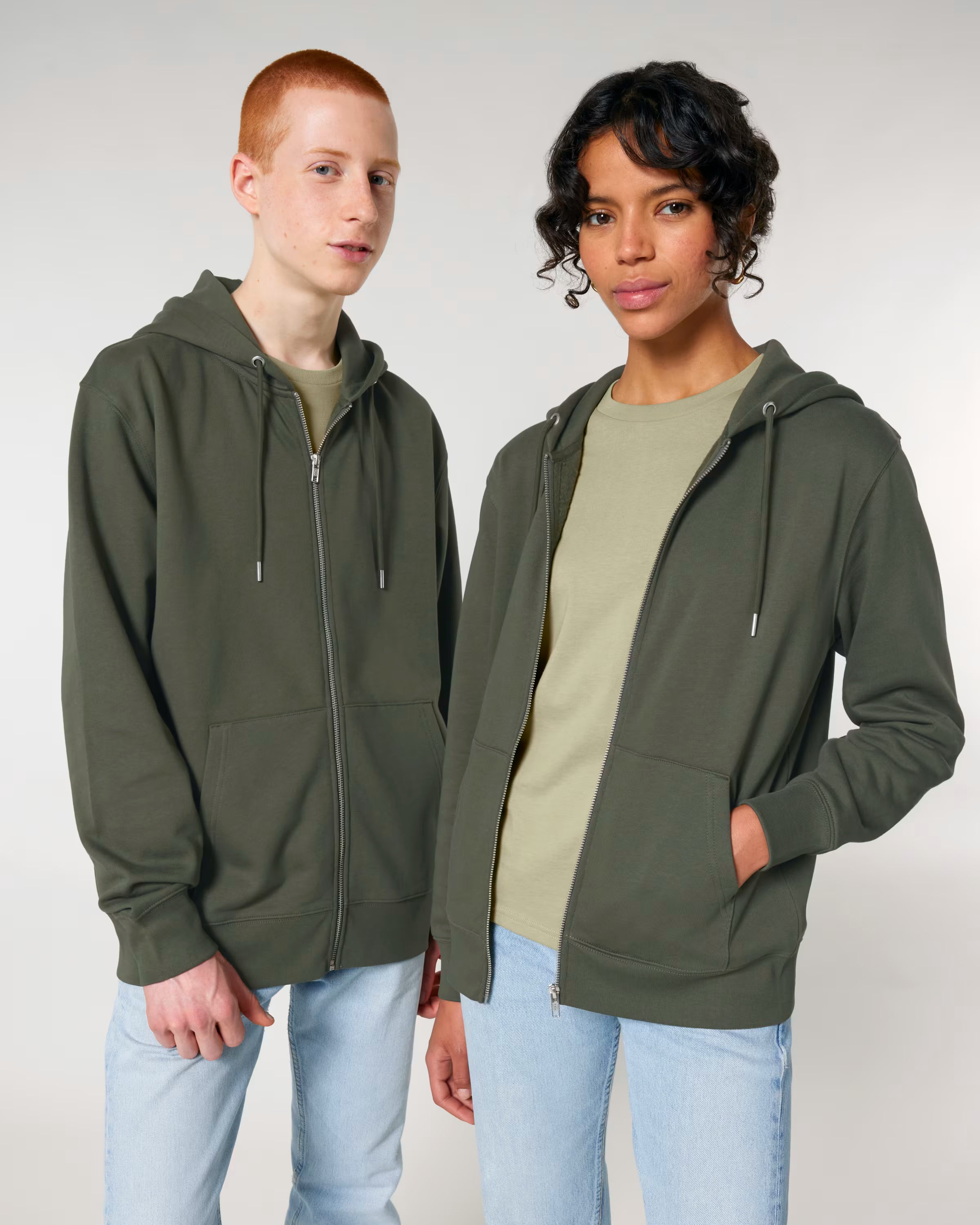 Front view of a male and female model wearing olive green cotton hoodies in studio