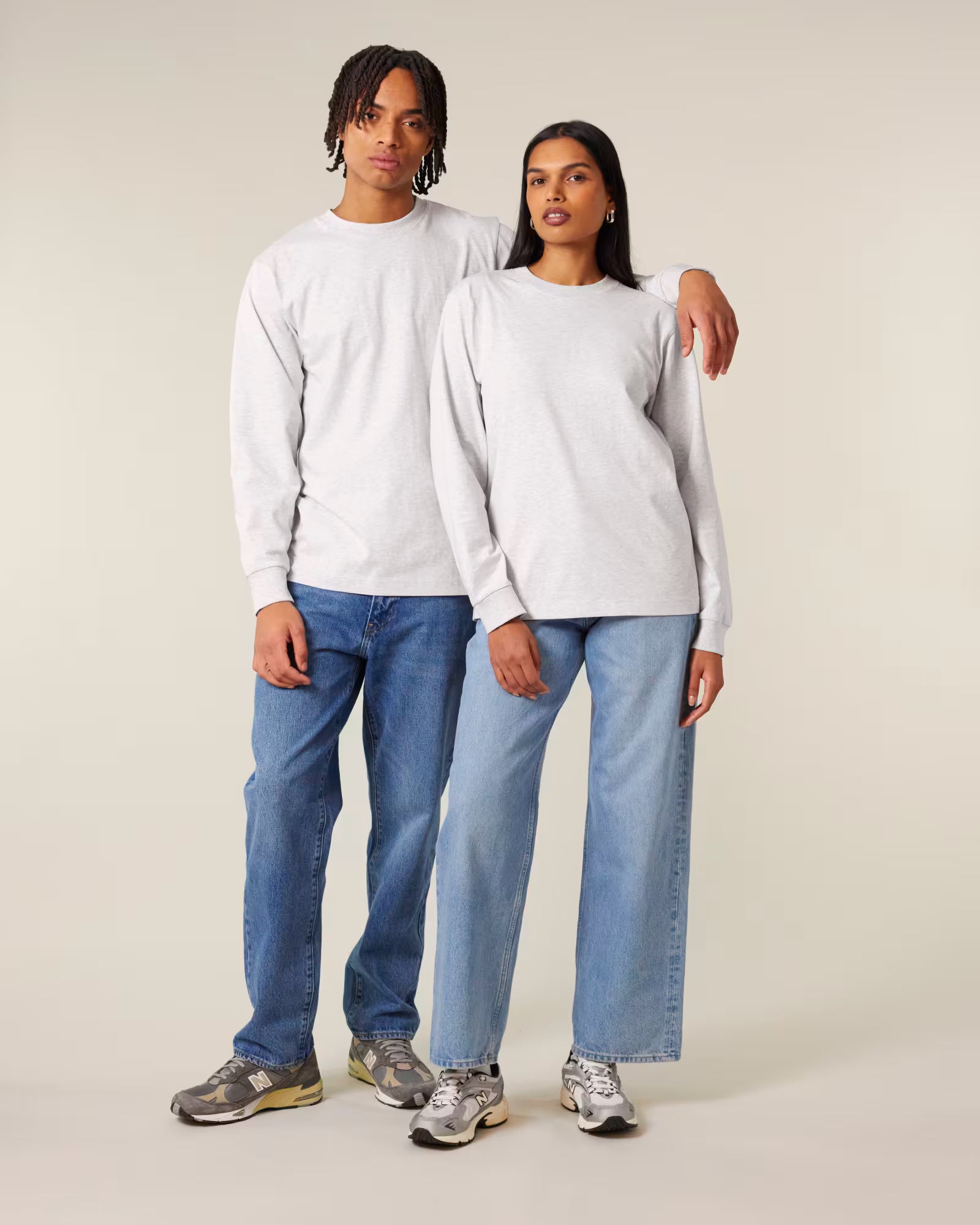Front view of male and female models wearing white cotton long sleeve t-shirts in studio