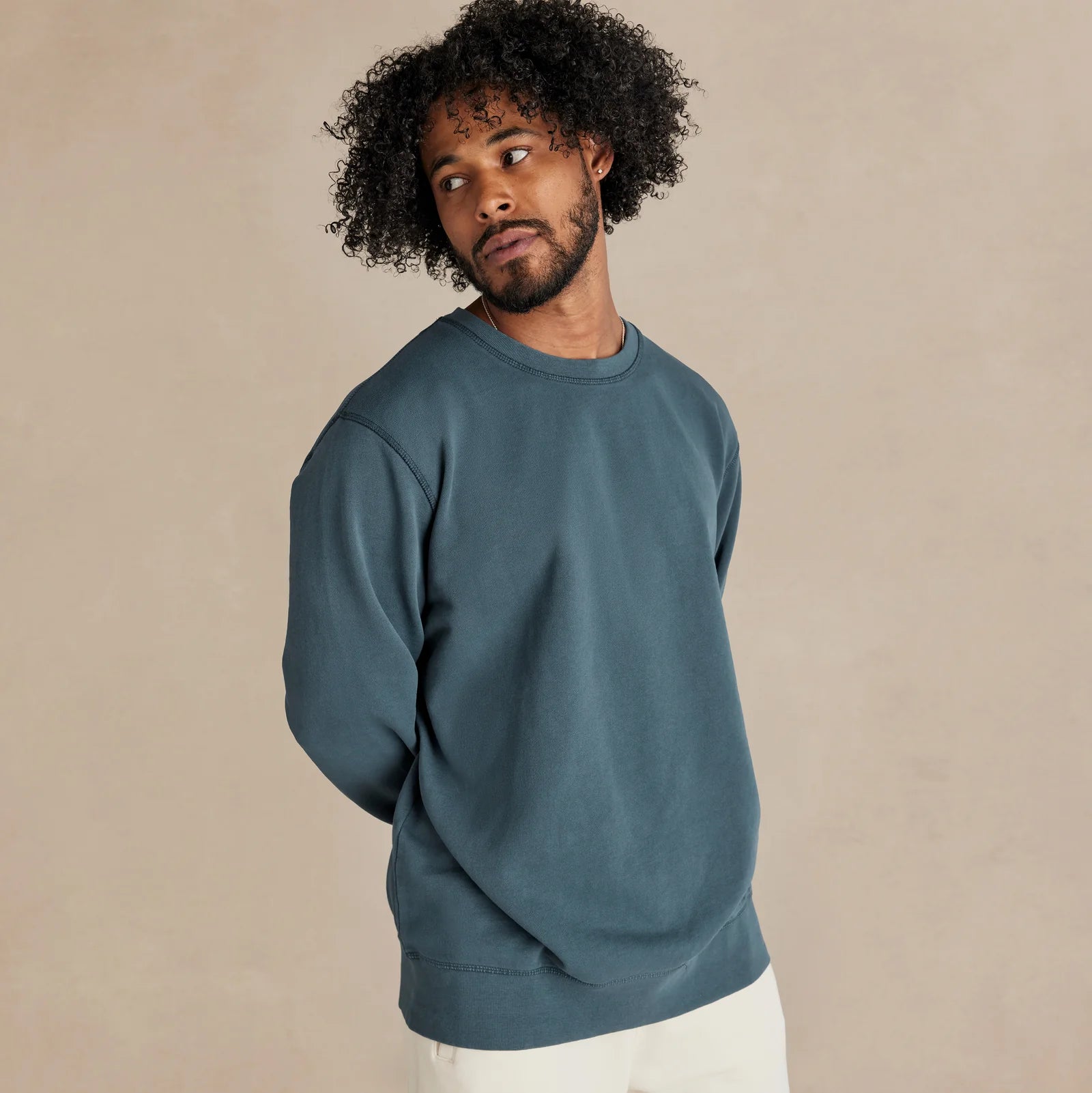 The Classic Crewneck deep teal sweatshirt worn by male model side view