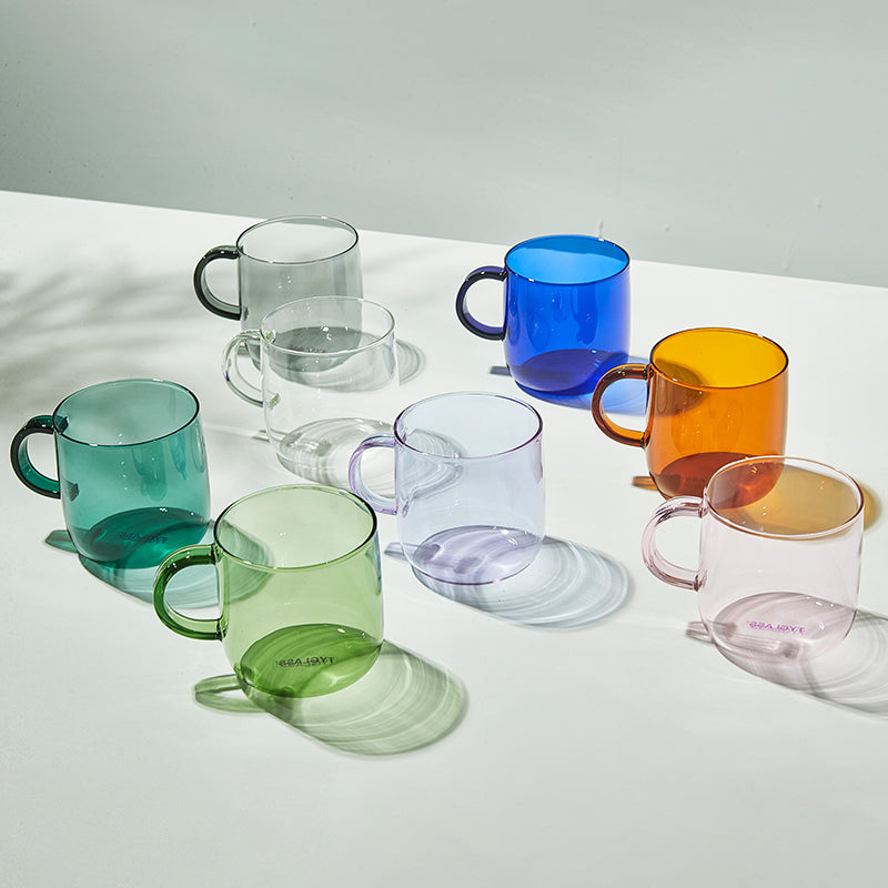 ceramic mugs in assorted colors styled on table, promotional merchandise with logo customization