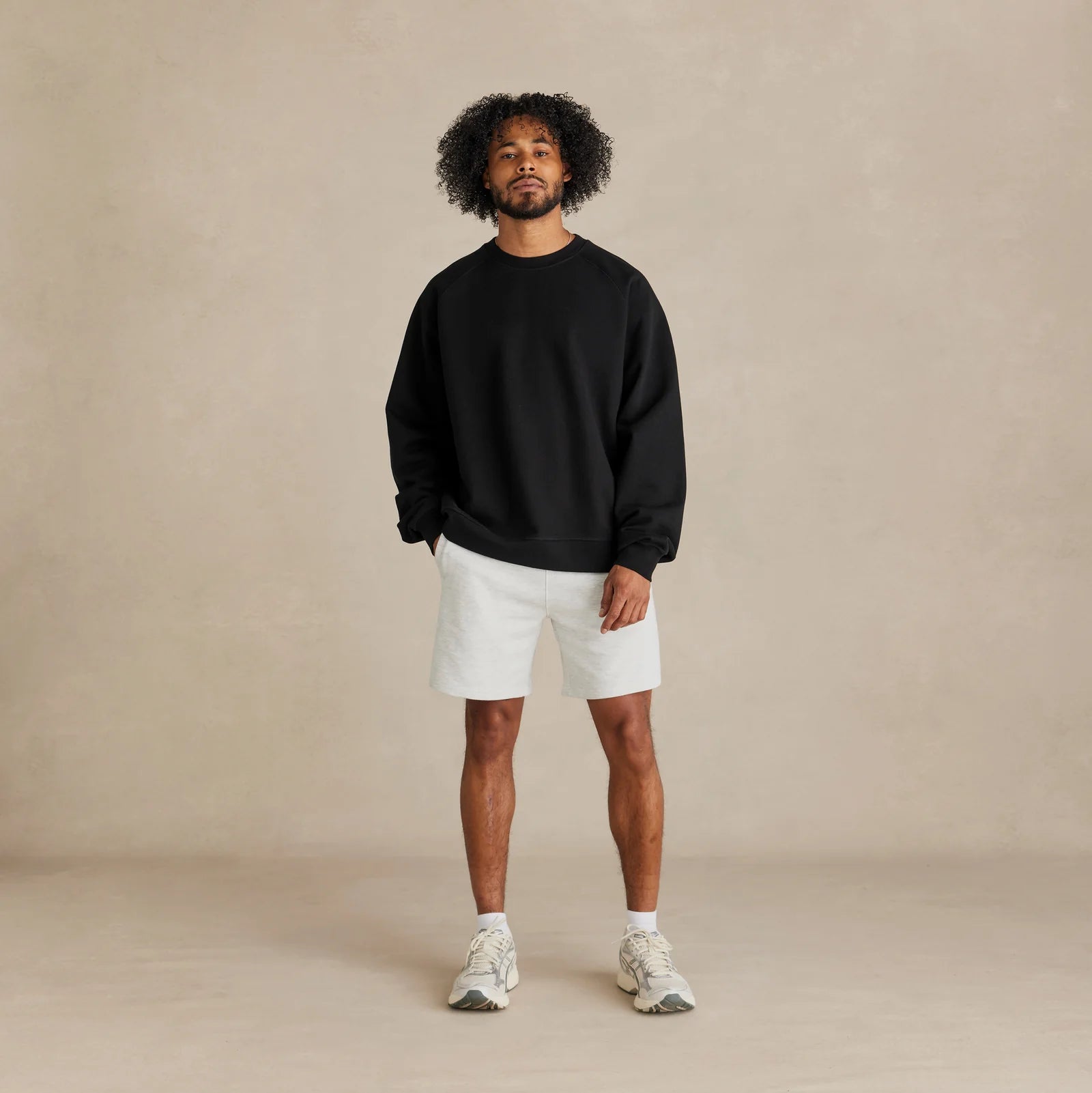 The Relaxed Crewneck black sweatshirt worn by male model relaxed fit