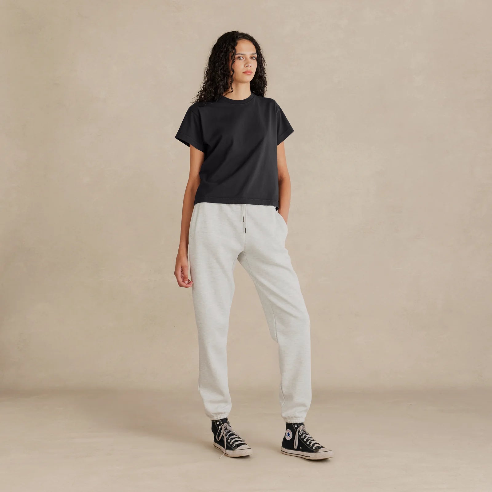 Woman wearing black Women’s Easy Fit Tee – relaxed fit, side angle