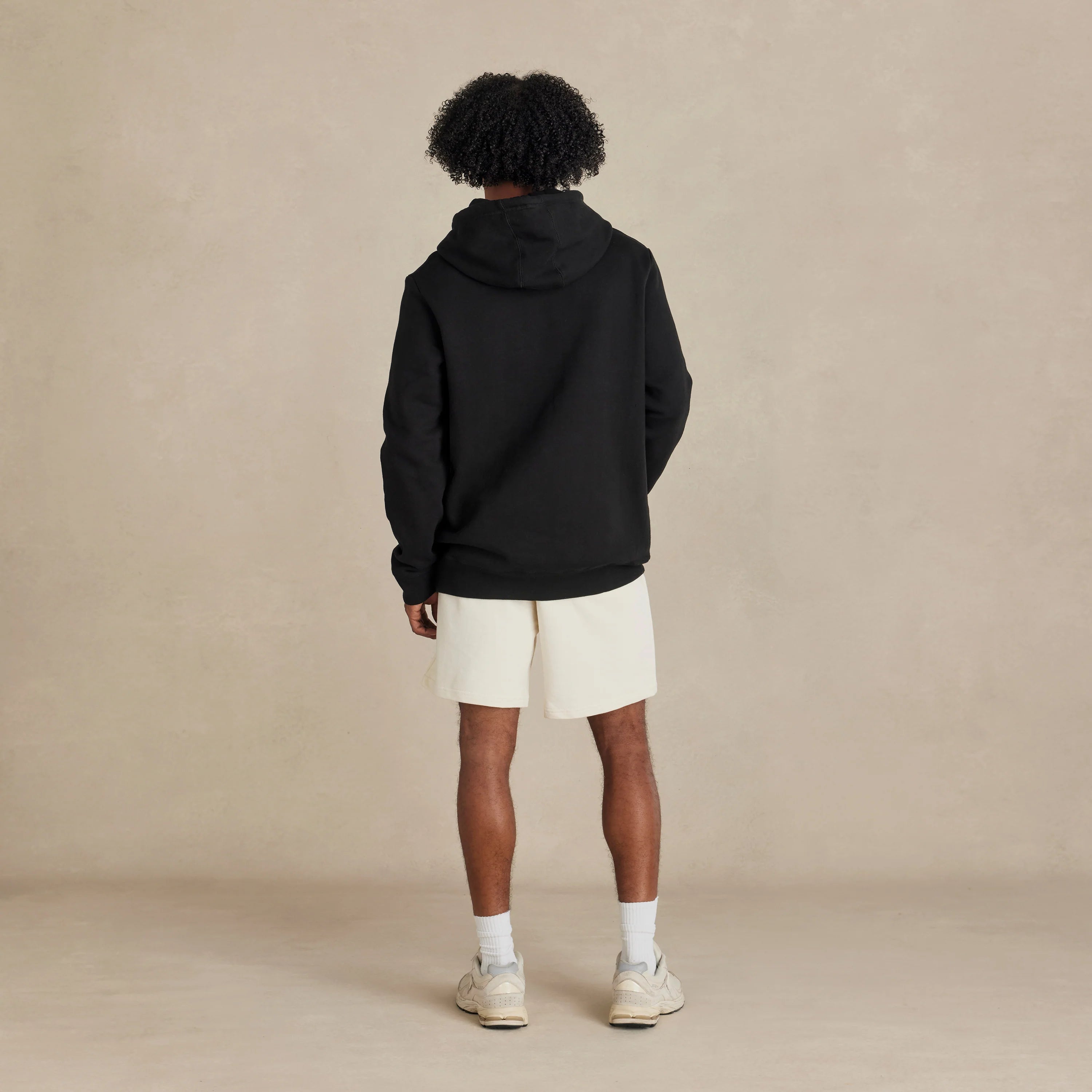 EMERCYN Essential Hoodie – black men’s premium cotton hoodie styled on male model