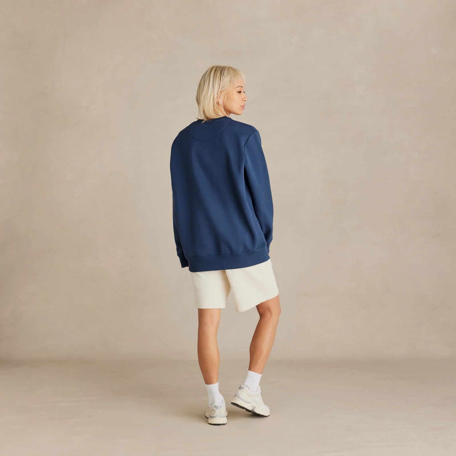 EMERCYN Essential Crewneck – navy blue unisex sweatshirt styled in lifestyle look