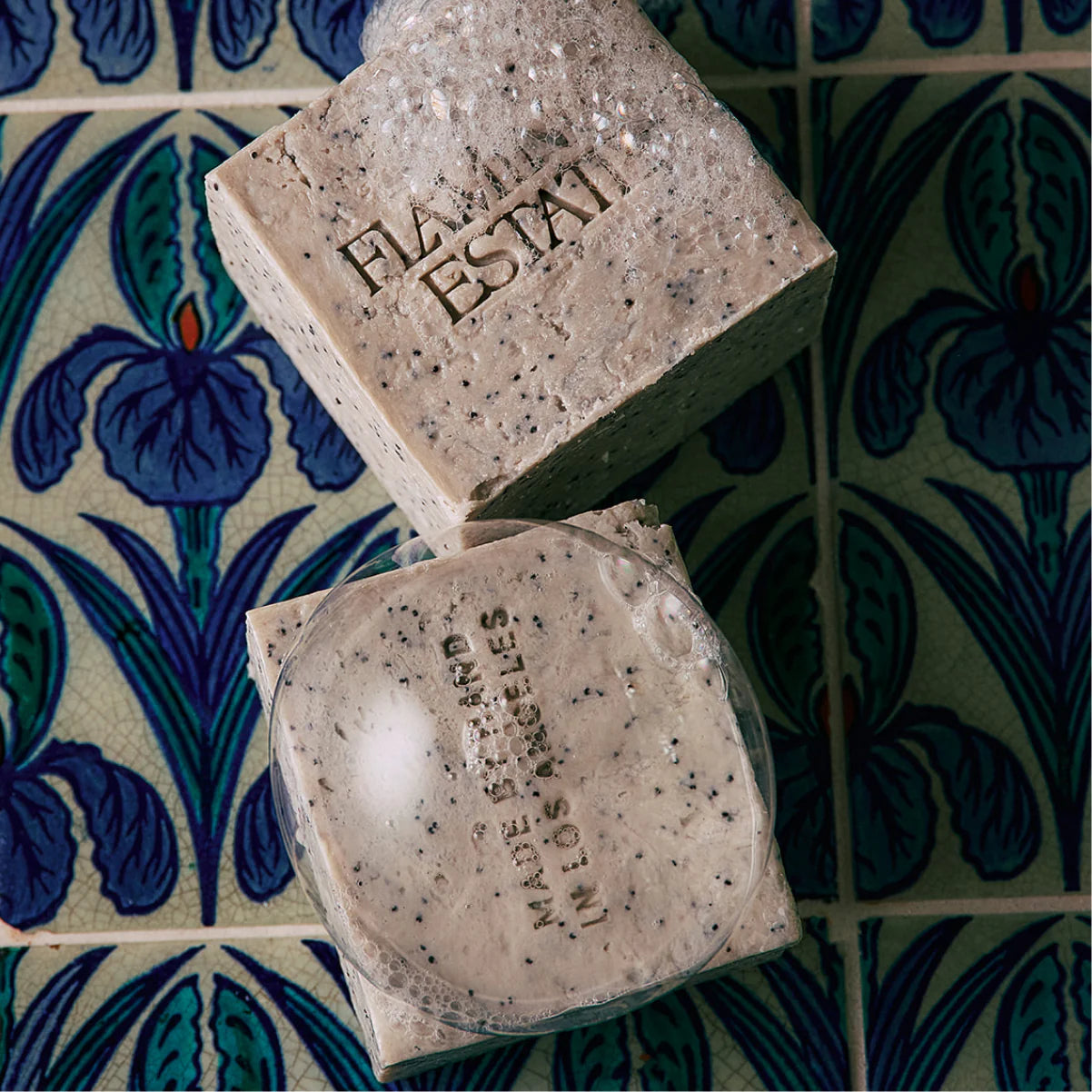 Two soap bars with 'Made Estai' branding on a decorative tile background