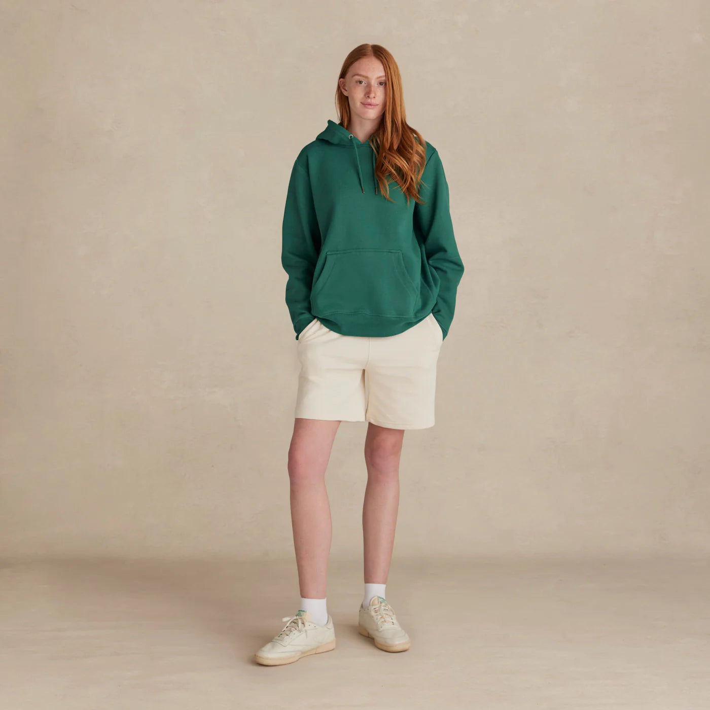 EMERCYN Essential Hoodie – pine green women’s premium cotton hoodie styled on male model