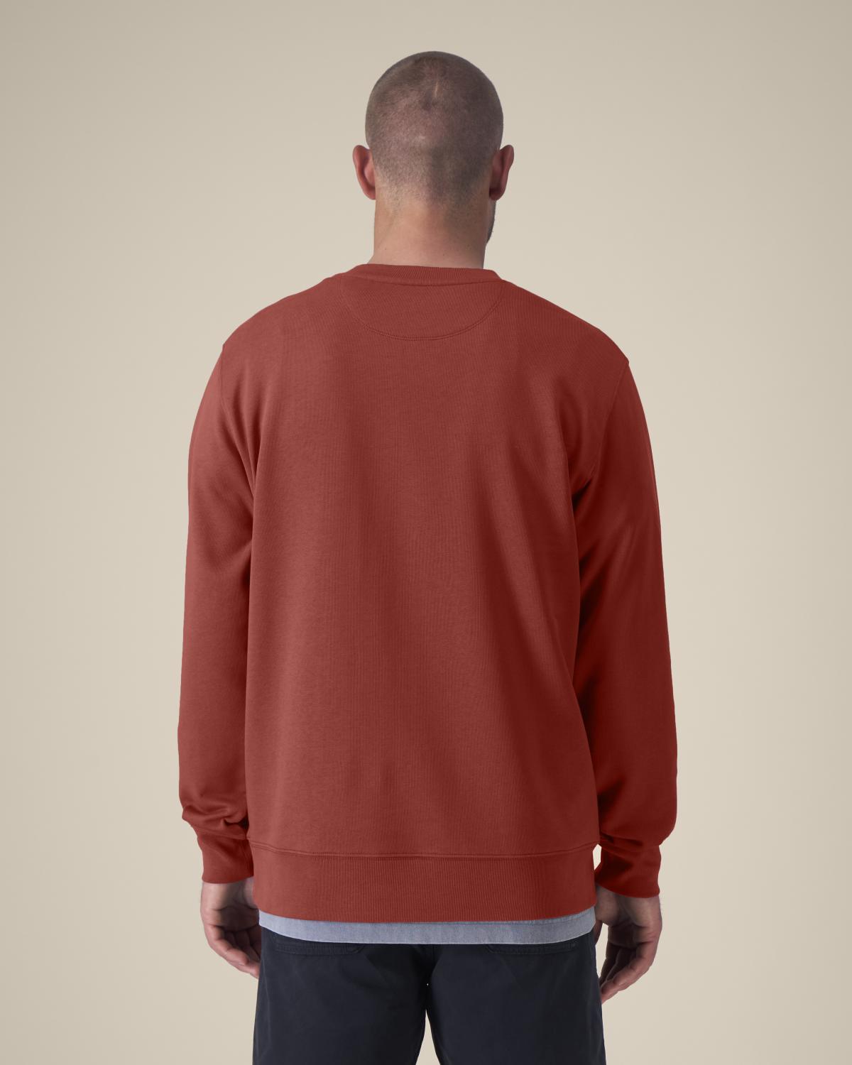 Person wearing a red cotton sweatshirt from behind on a beige background