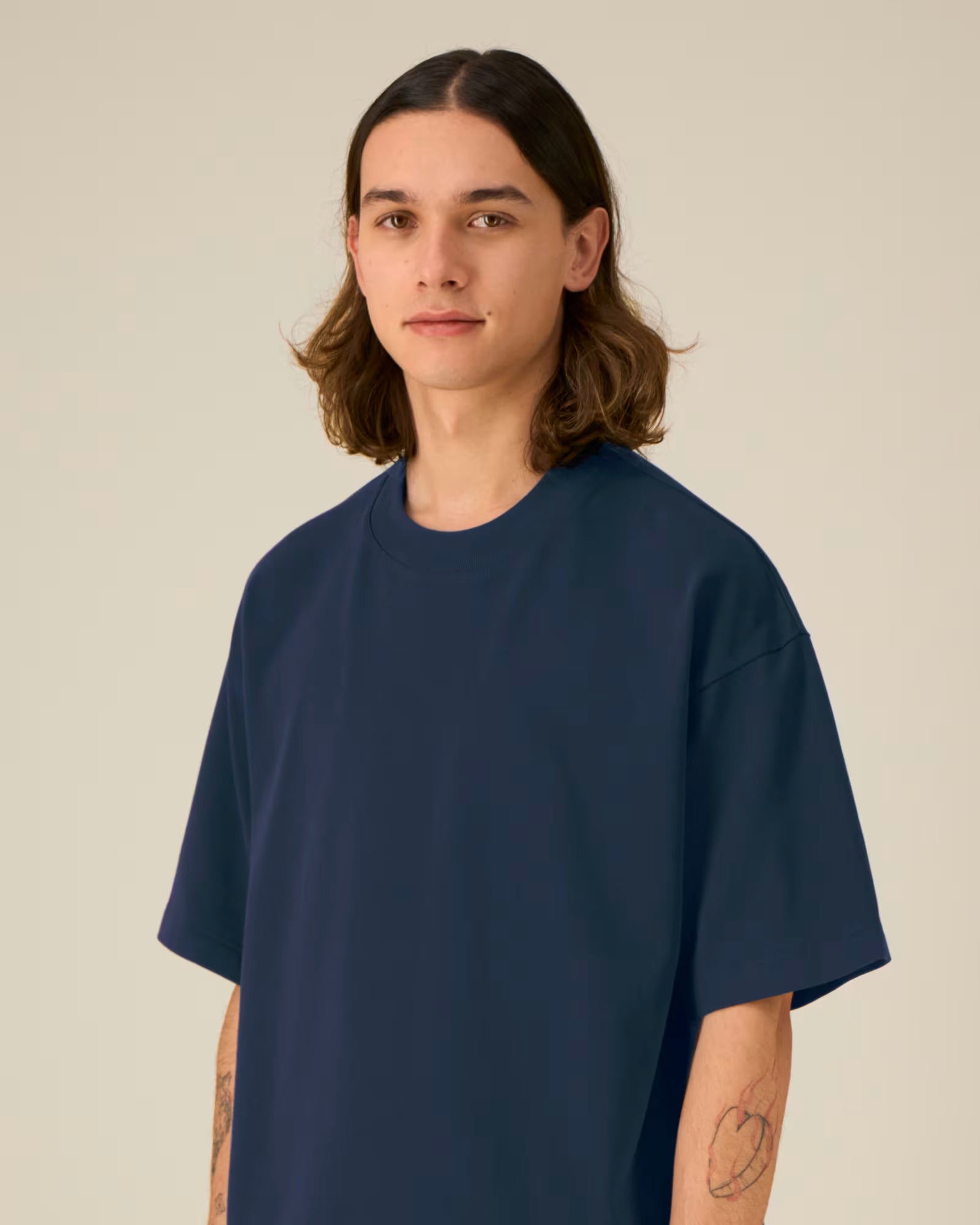 Front detail view of a female model wearing a navy blue cotton t-shirt in studio