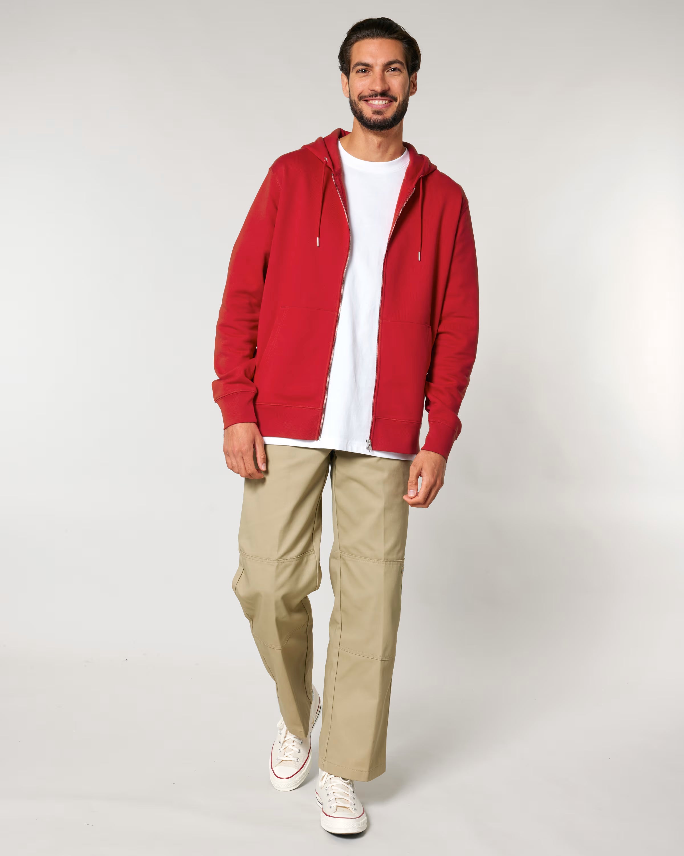 Man wearing a red cotton hoodie, white t-shirt, beige pants, and white sneakers ideal for customization