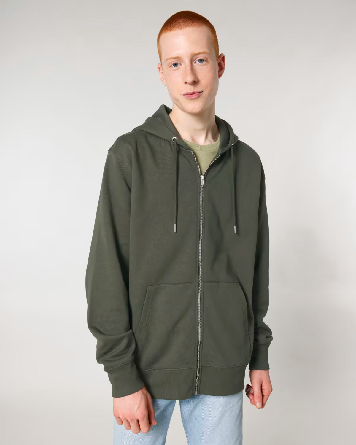 front view of a male model wearing an olive green cotton hoodie in studio