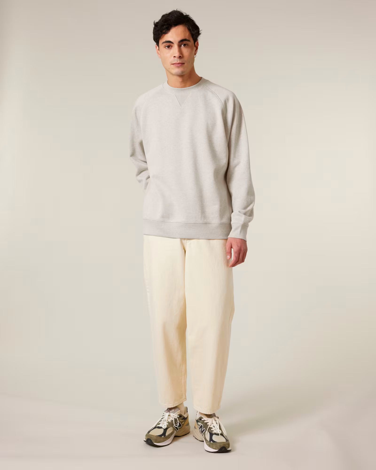 Front view of a man model wearing a beige cotton sweatshirt in studio