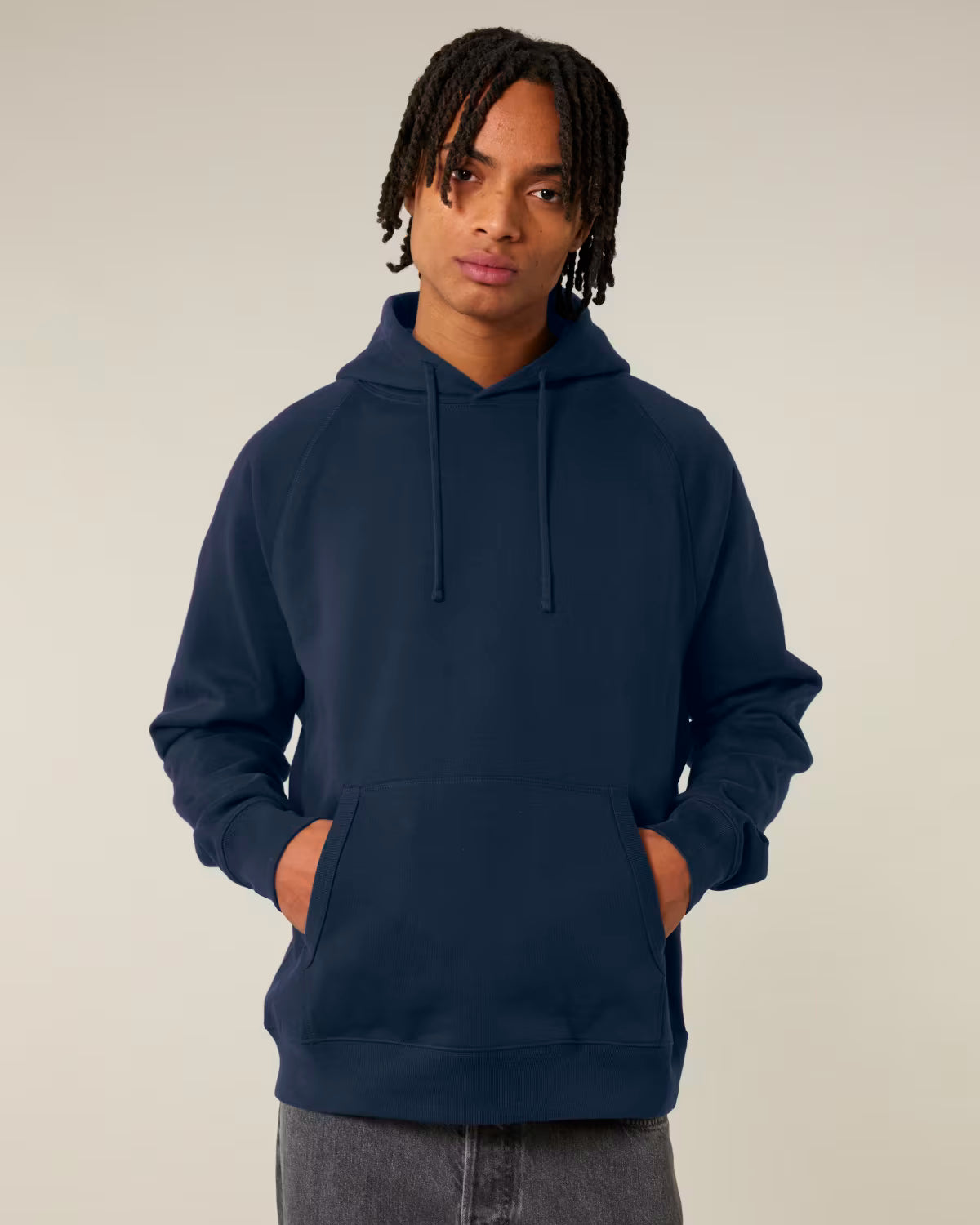 Front view of a female model wearing a navy cotton hoodie in studio