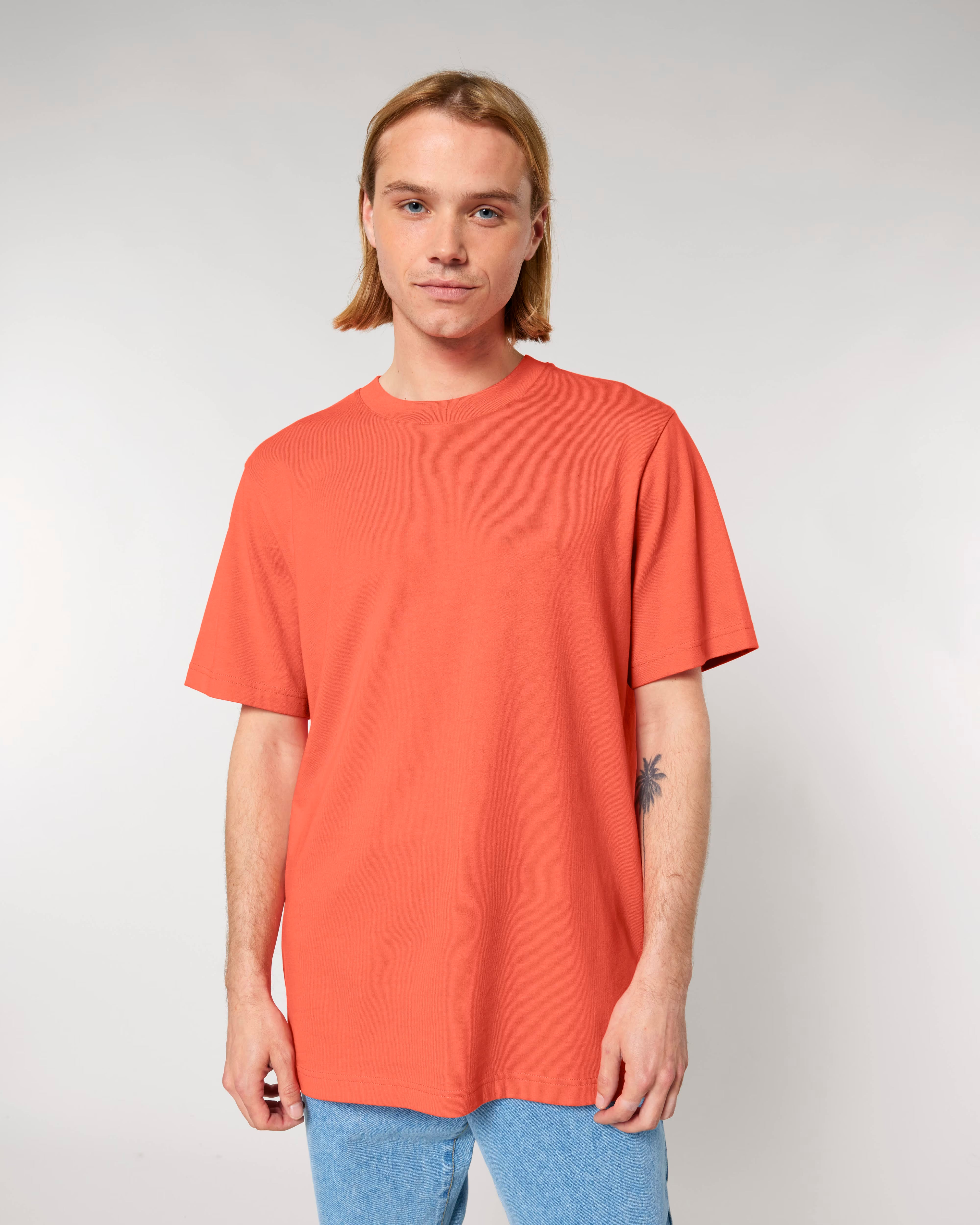 coral orange unisex cotton t-shirt on model, relaxed fit
