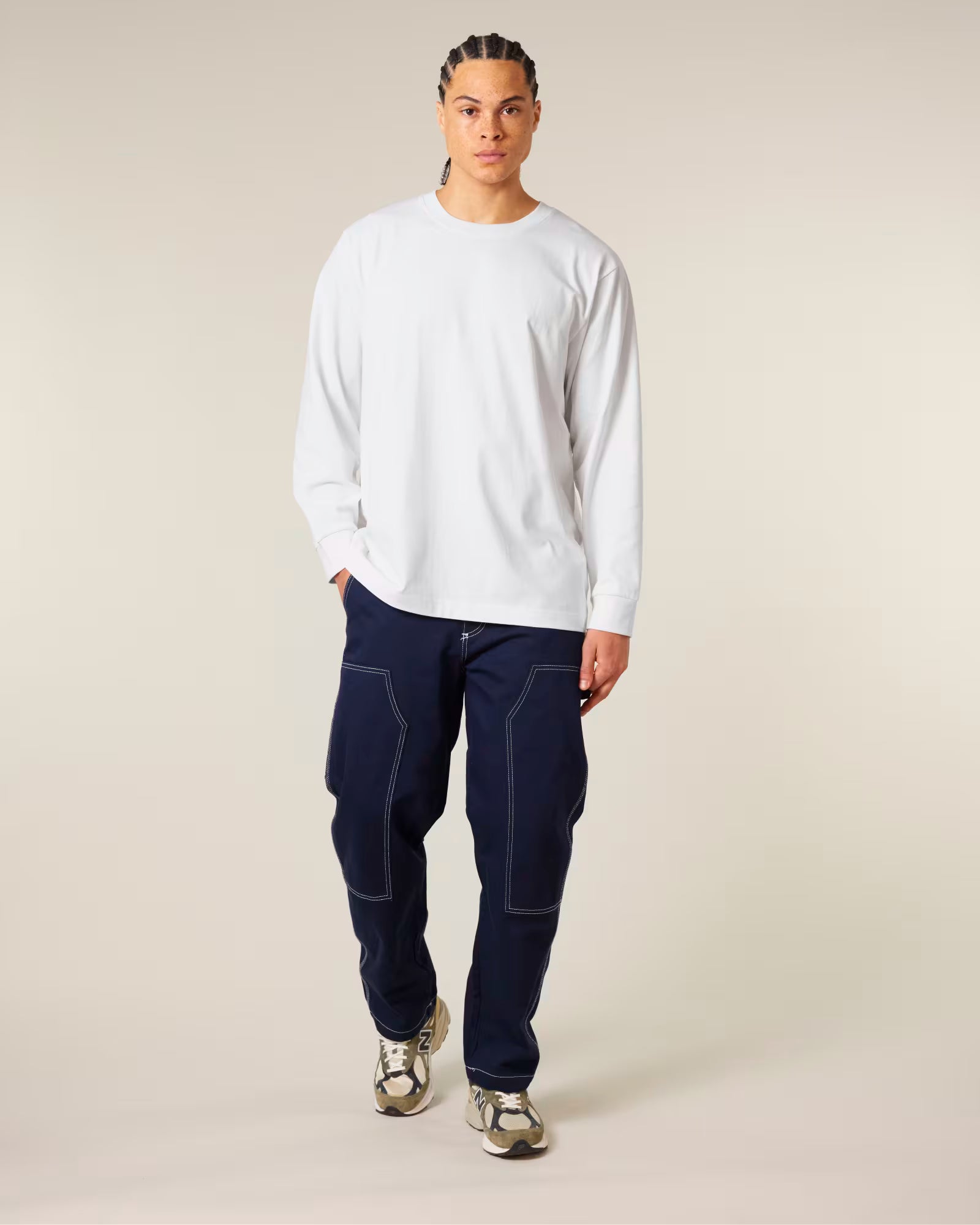 Front view of a male model wearing a white cotton long sleeve t-shirt in studio