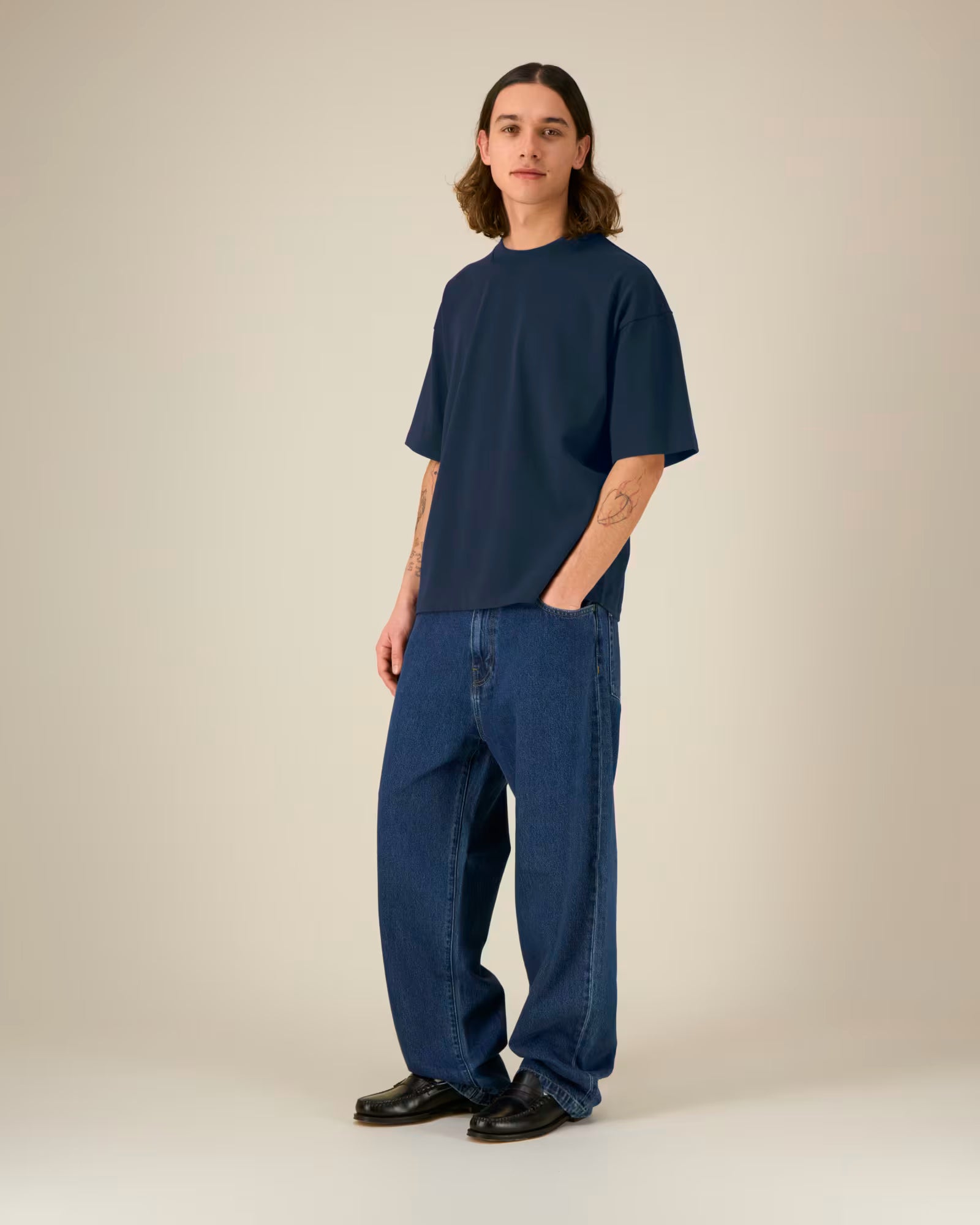 Full body front view of a male model wearing a navy blue cotton t-shirt in studio