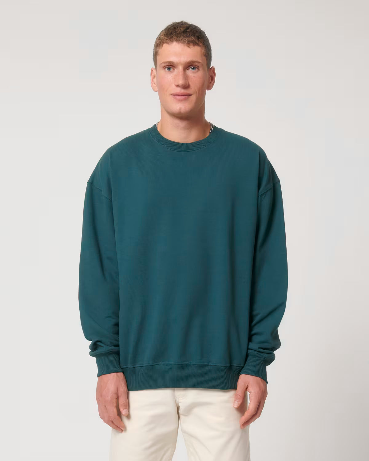 Front view of a male model wearing a teal cotton hoodie in studio