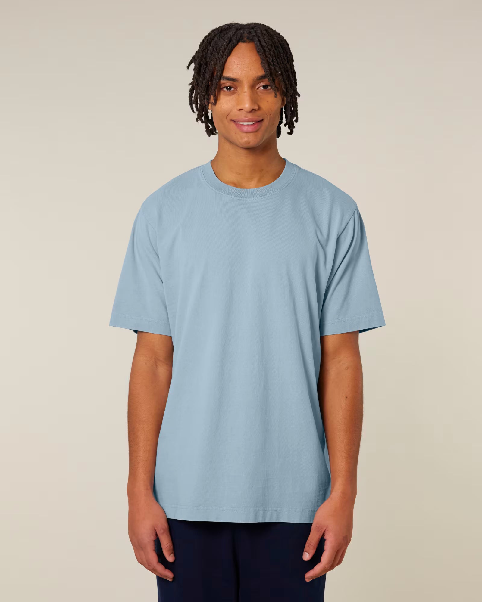 Front view of a male model wearing a light blue cotton t-shirt in studio