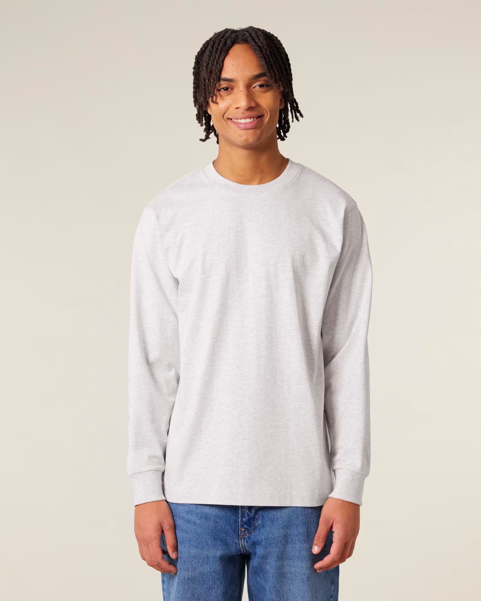 Front view of a male model wearing a white cotton long sleeve t-shirt in studio