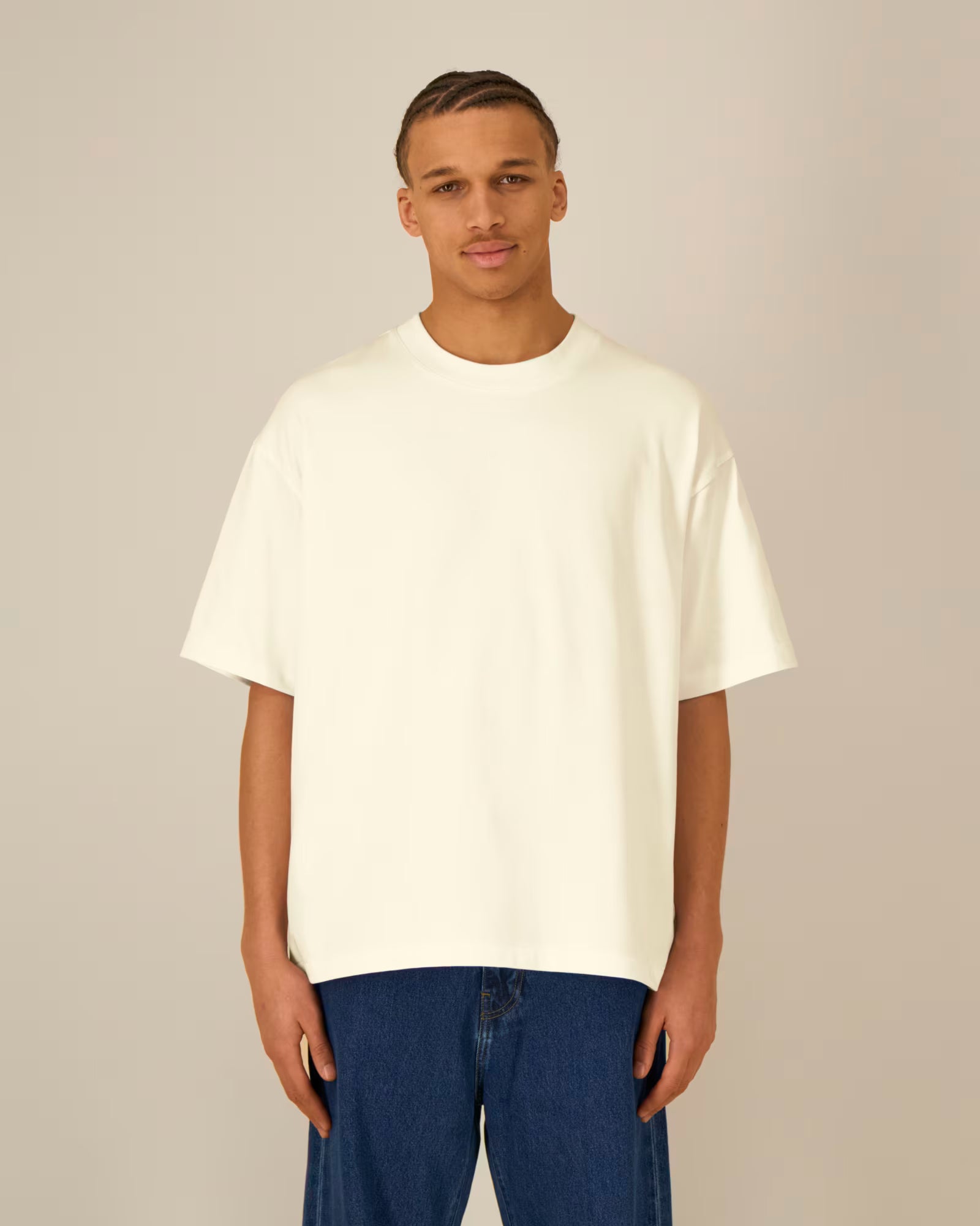 Front view of a male model wearing a natural beige cotton t-shirt in studio