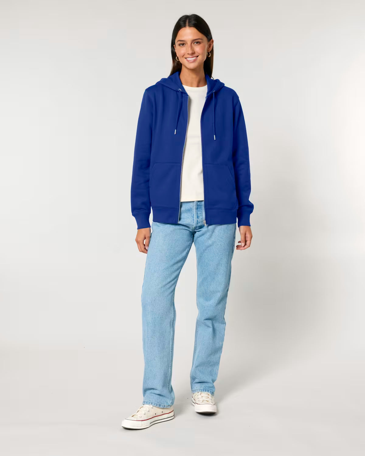 Person wearing a blue cotton hoodie, white shirt, and light blue jeans on a white background