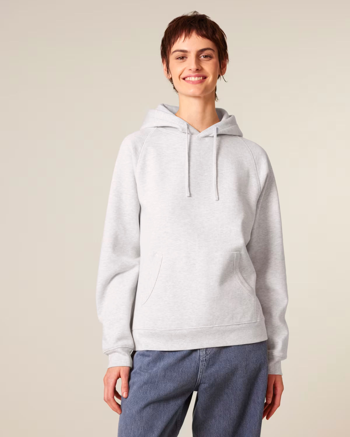 Front view of a female model wearing a white cotton hoodie in studio