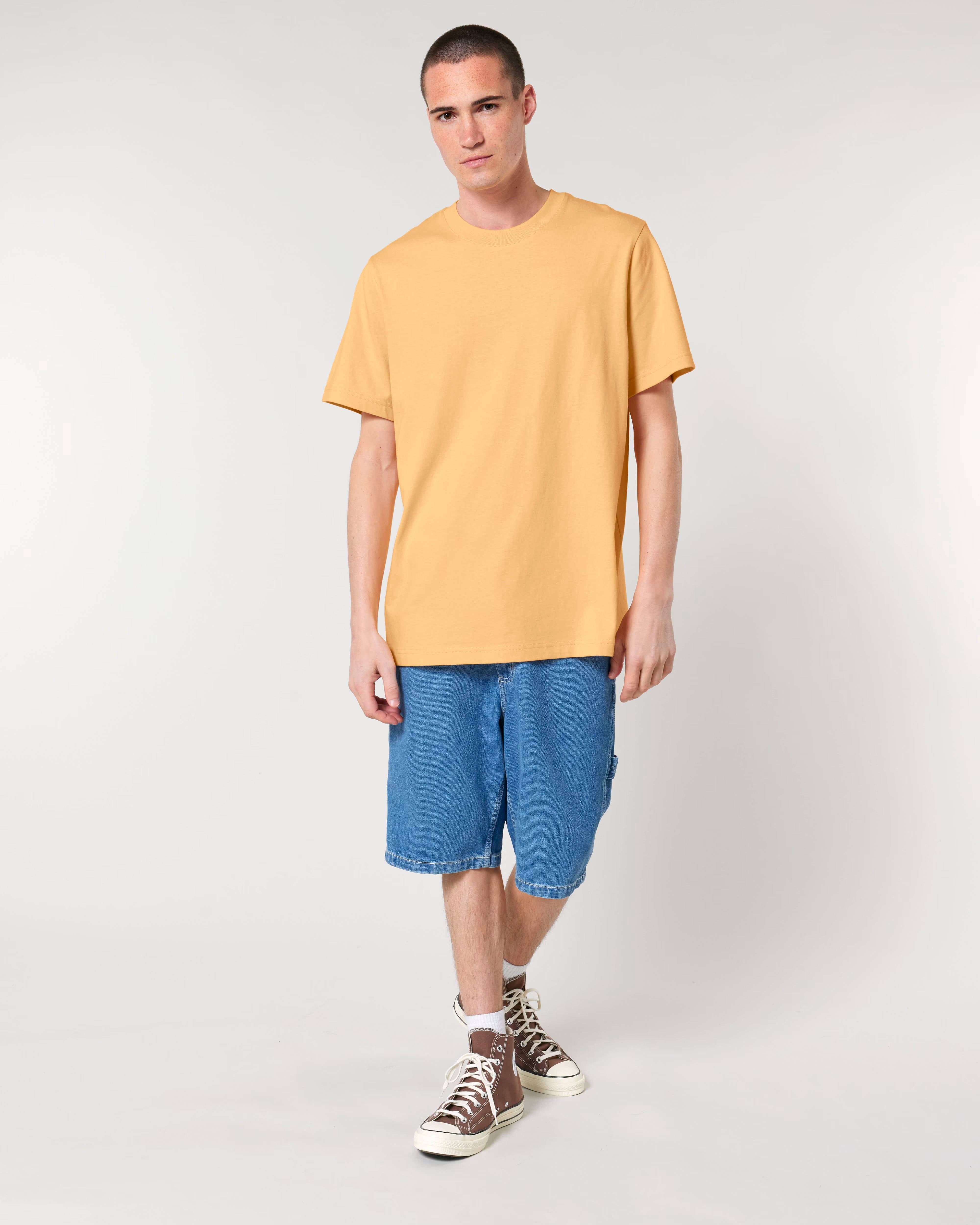 warm yellow unisex cotton t-shirt on model, relaxed fit