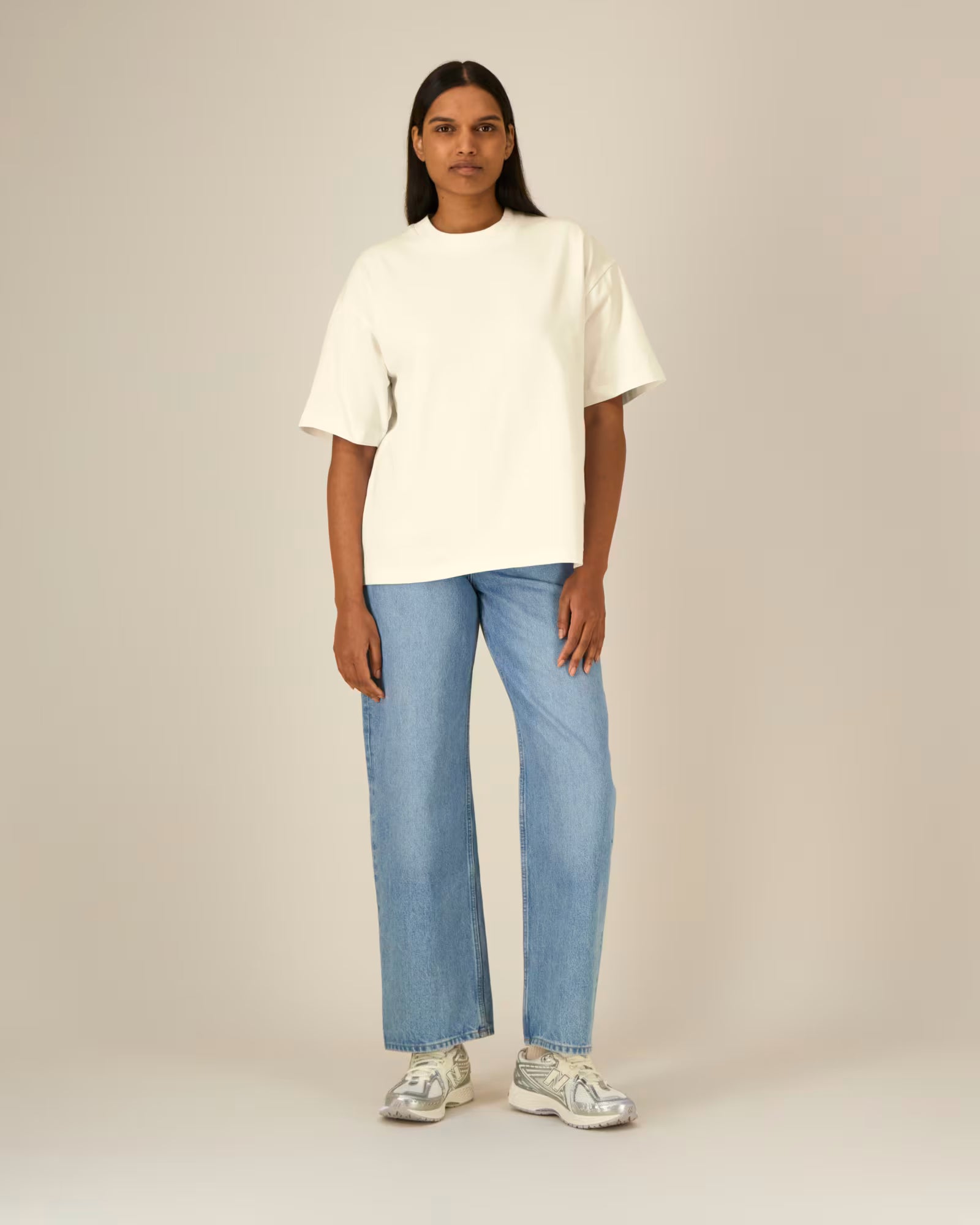 Full body front view of a female model wearing a natural beige cotton t-shirt in studio