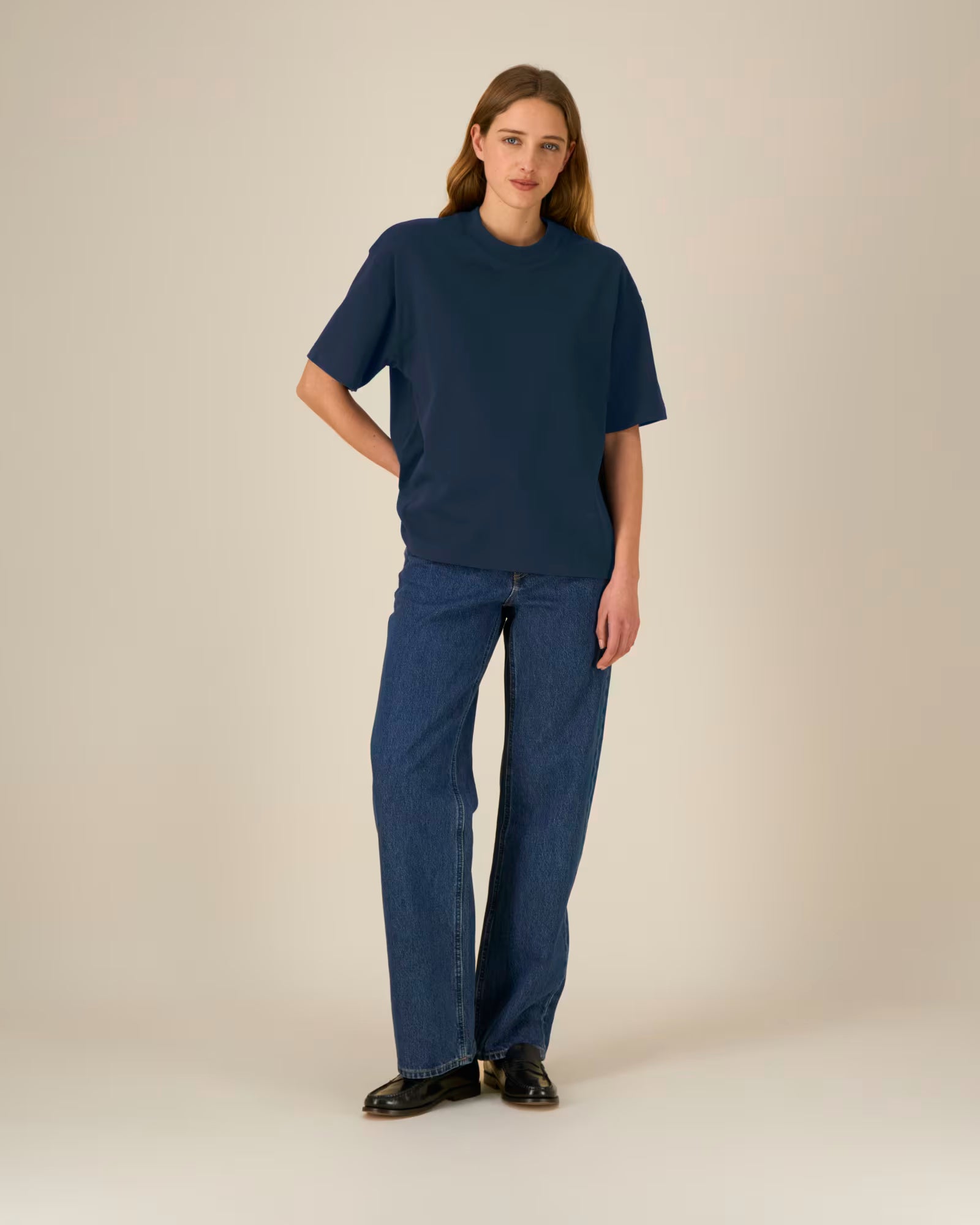 Full body front view of a female model wearing a navy blue cotton t-shirt in studio
