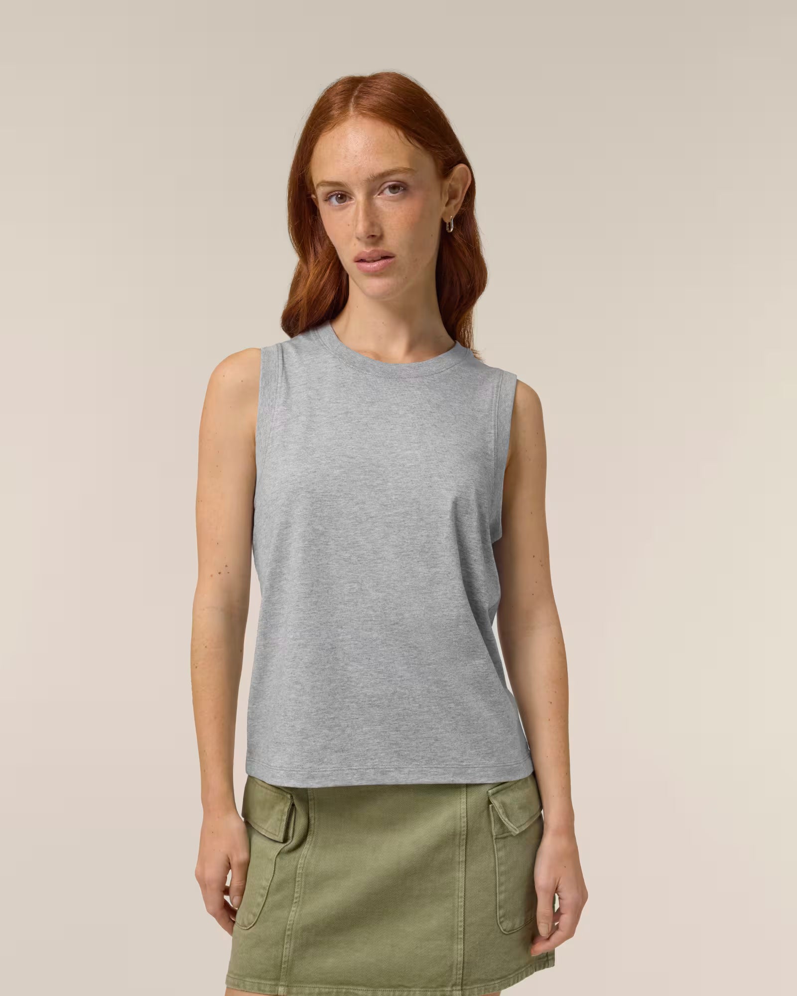 Front view of a female model wearing a light grey cotton sleeveless top in studio