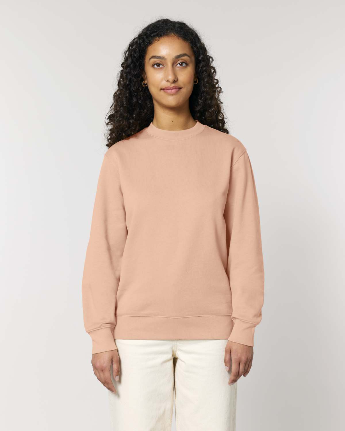Woman wearing a beige unisex cotton hoodie isolated on white background