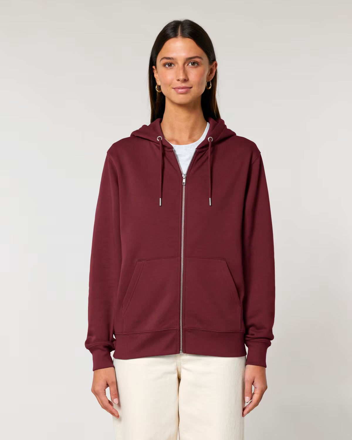 Woman wearing a cotton maroon hoodie on a plain background
