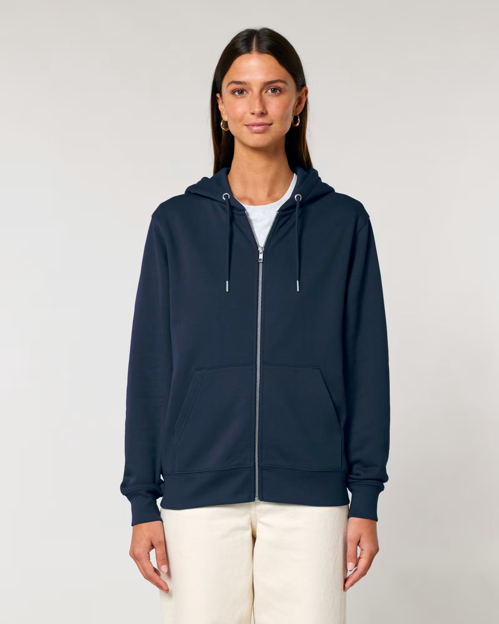 Woman wearing a navy blue cotton hoodie on a plain background