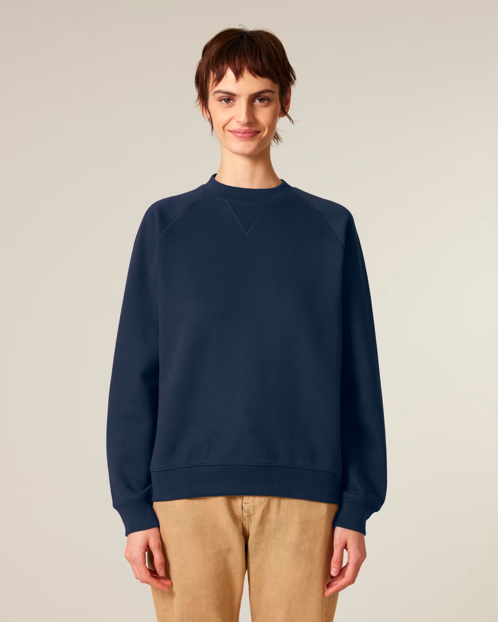 Front view of a male model wearing a navy cotton sweatshirt in studio