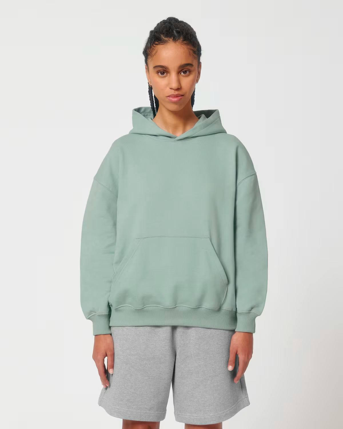 Front view of a male model wearing a mint green cotton hoodie in studio