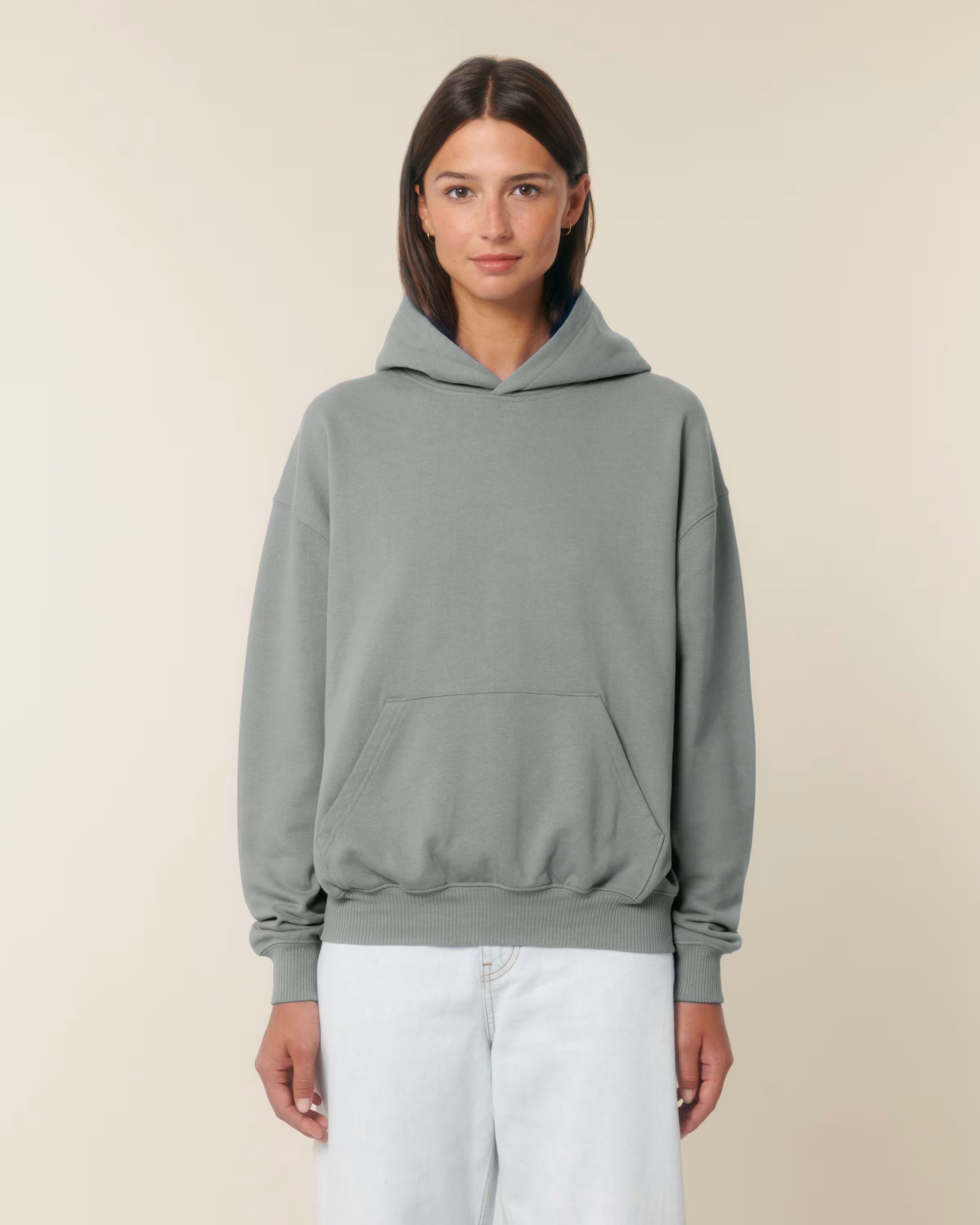 Front view of a male model wearing a sage green cotton hoodie in studio