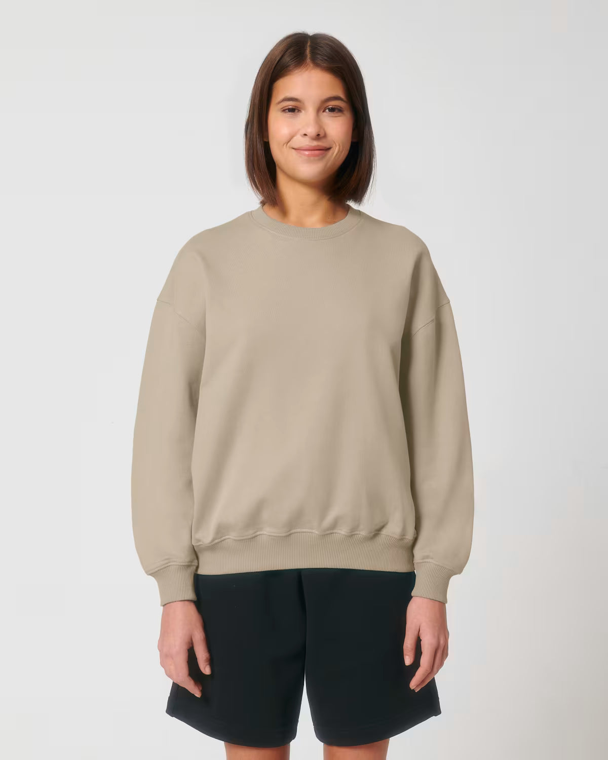 Front view of a female model wearing a Brown light cotton hoodie in studio