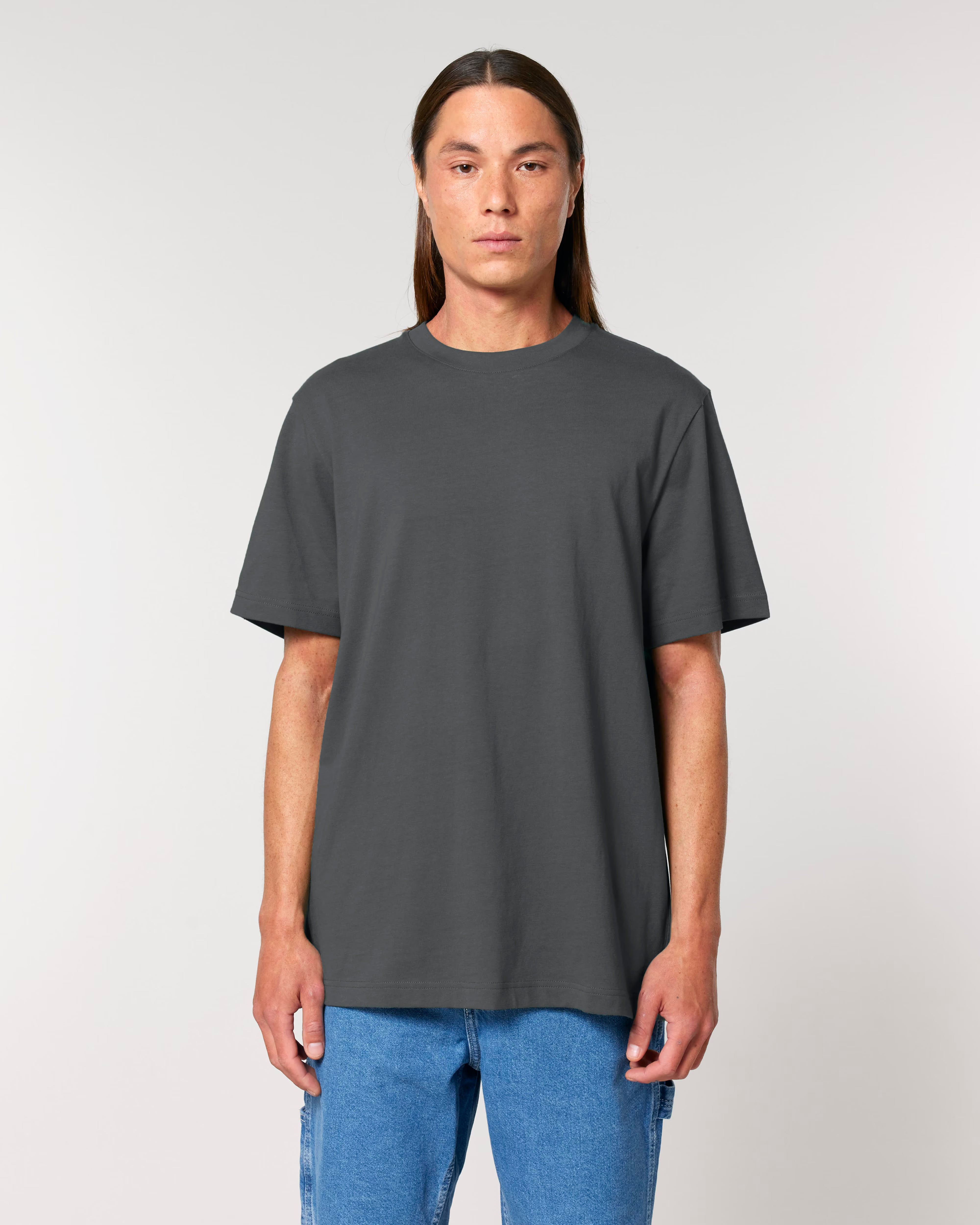 Person wearing a plain dark gray t-shirt against a light background