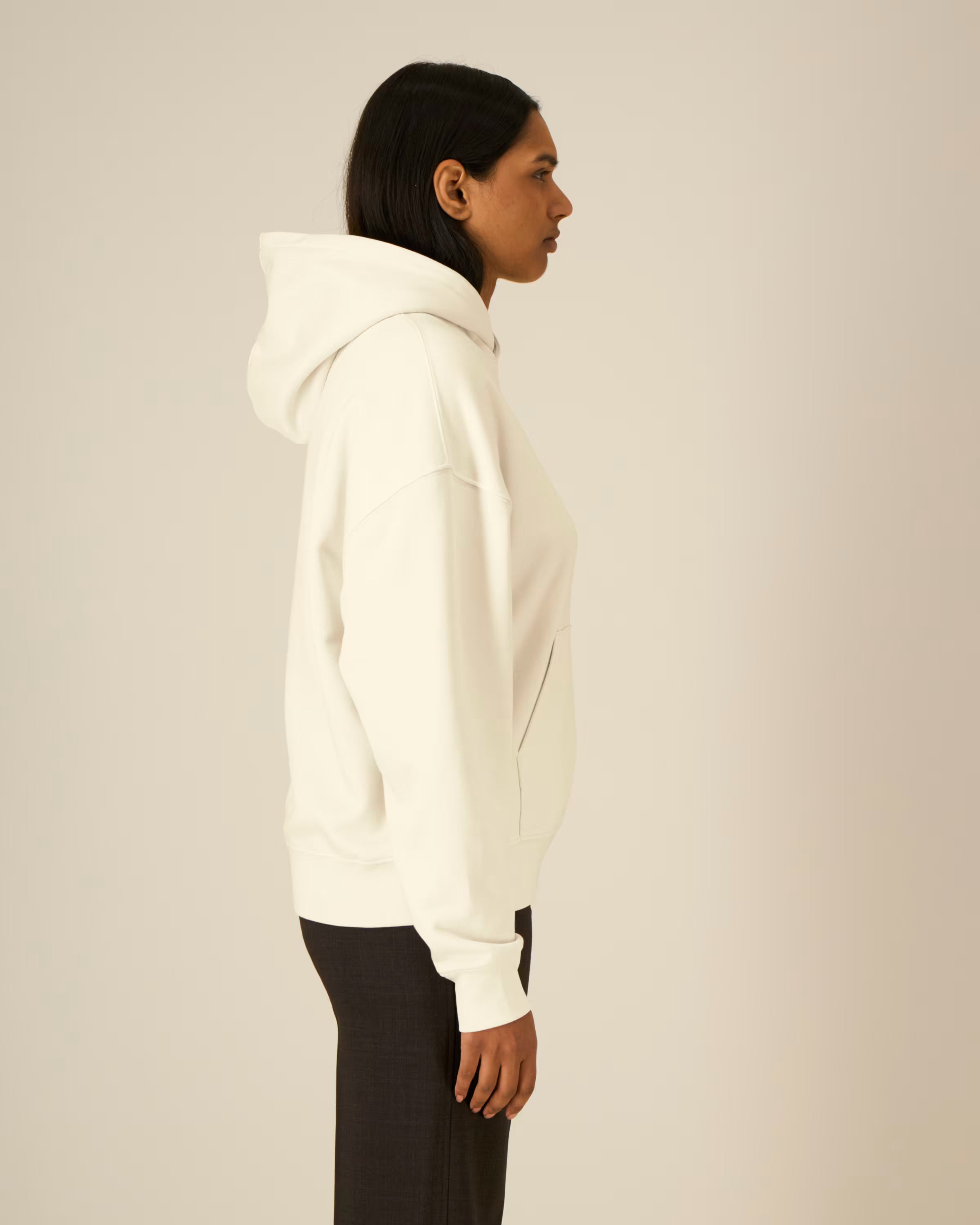 Person wearing a white unisex cotton hoodie against a plain background