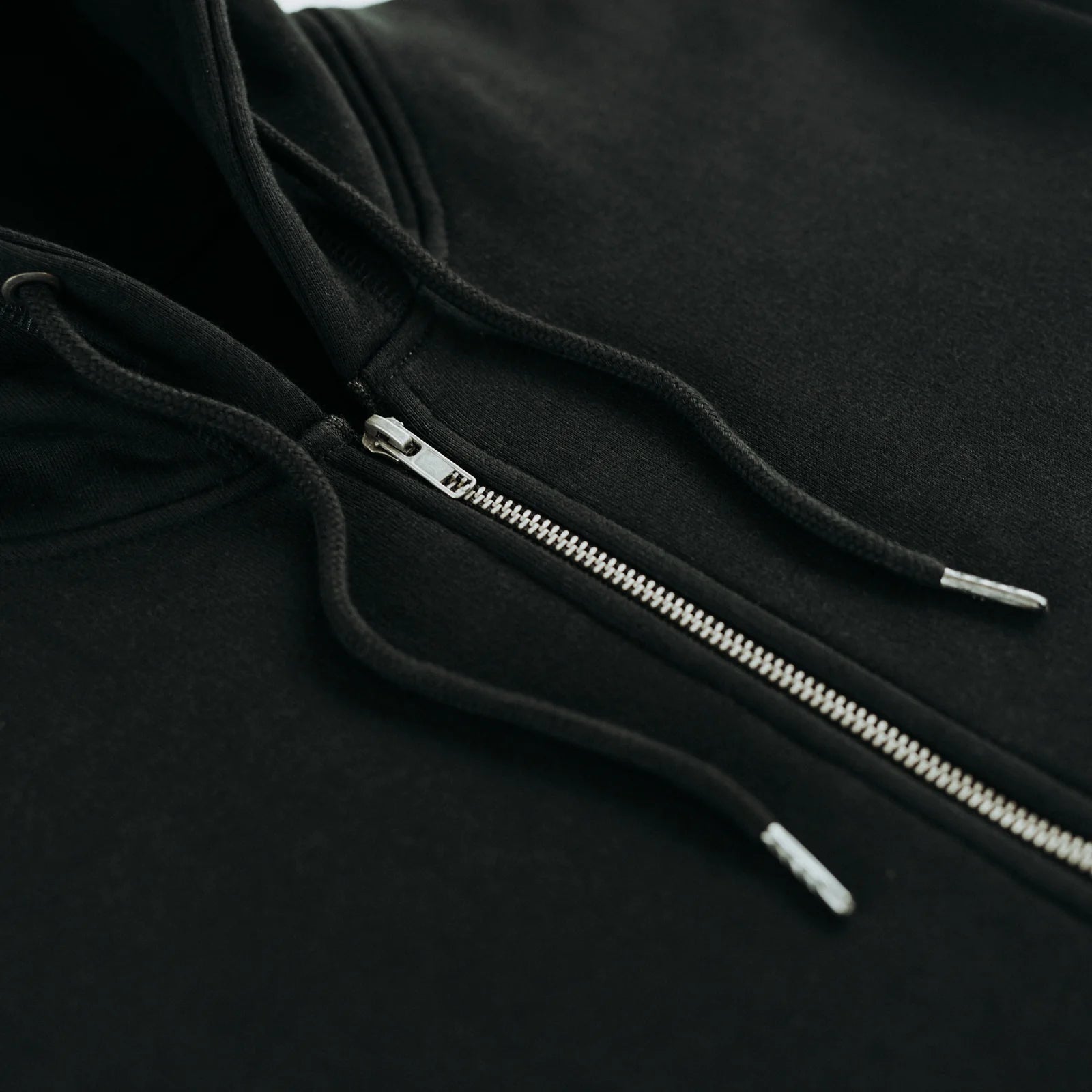 The Signature Zip black metal zipper detail close-up