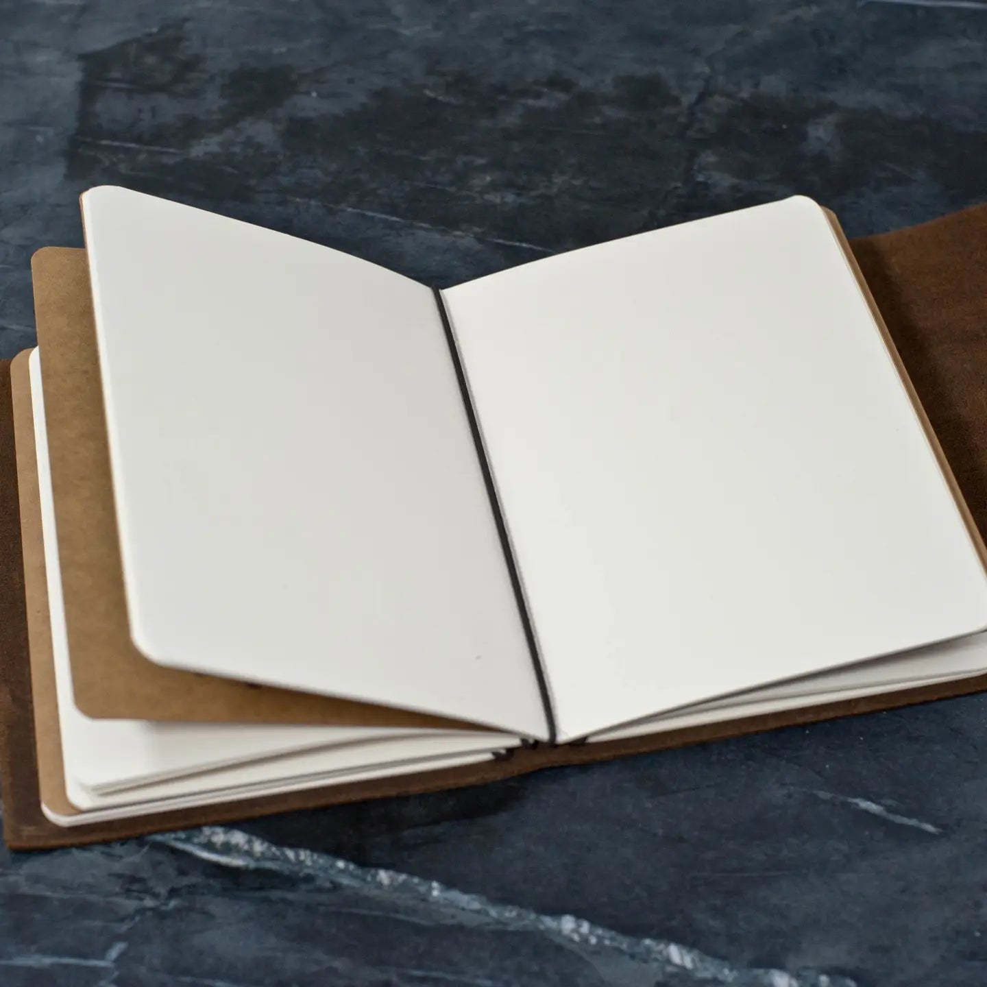open leather journal with blank pages, customizable corporate gift notebook