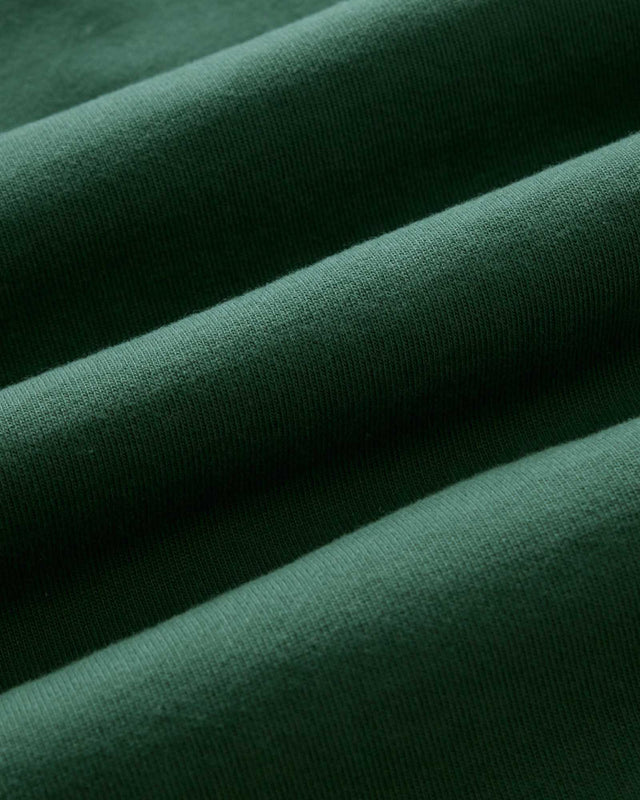 Close-up of dark green fabric with a textured surface