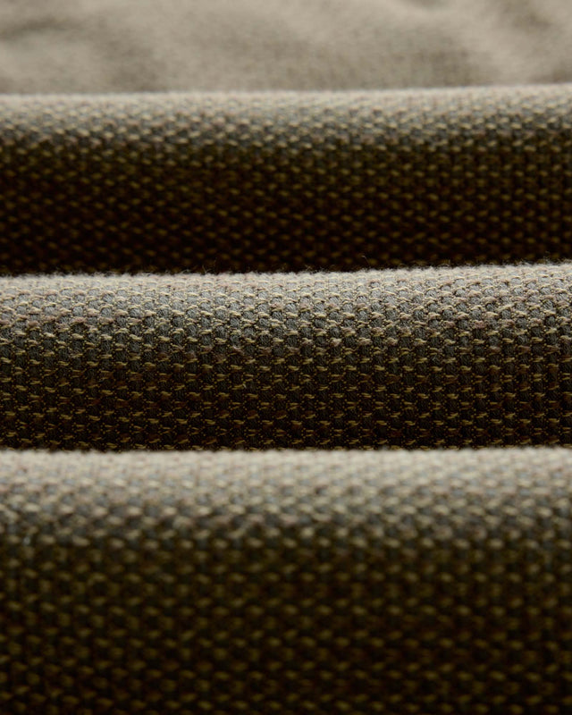 Textured olive green fabric close up