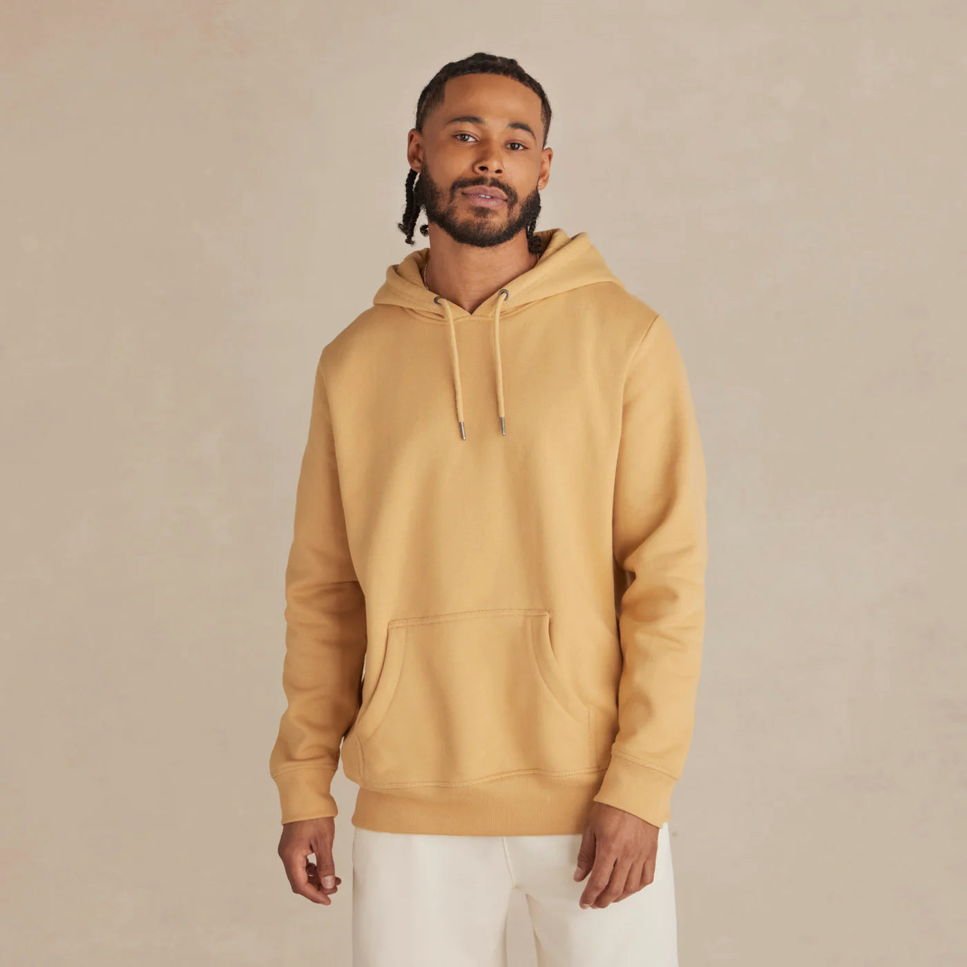 EMERCYN Essential Hoodie –Man wearing a mustard butter yellow unisex premium cotton hoodie